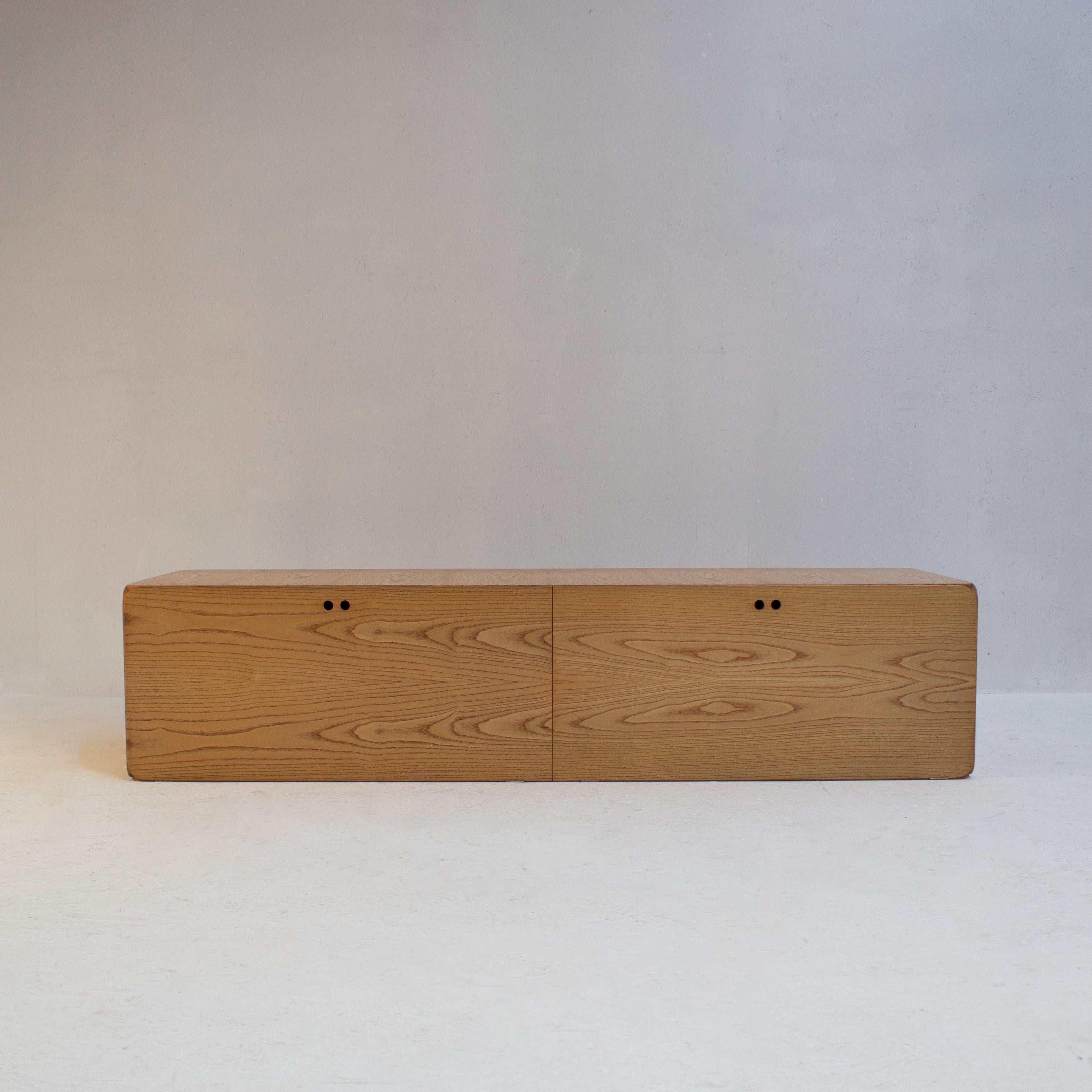 Derk Jan De Vries Samara Locker Storage Unit for Maisa , 1970s. This sleek and functional vintage piece features a minimalist design, with a large storage compartment concealed behind a simple wooden door with a unique wooden pull. The unit’s clean