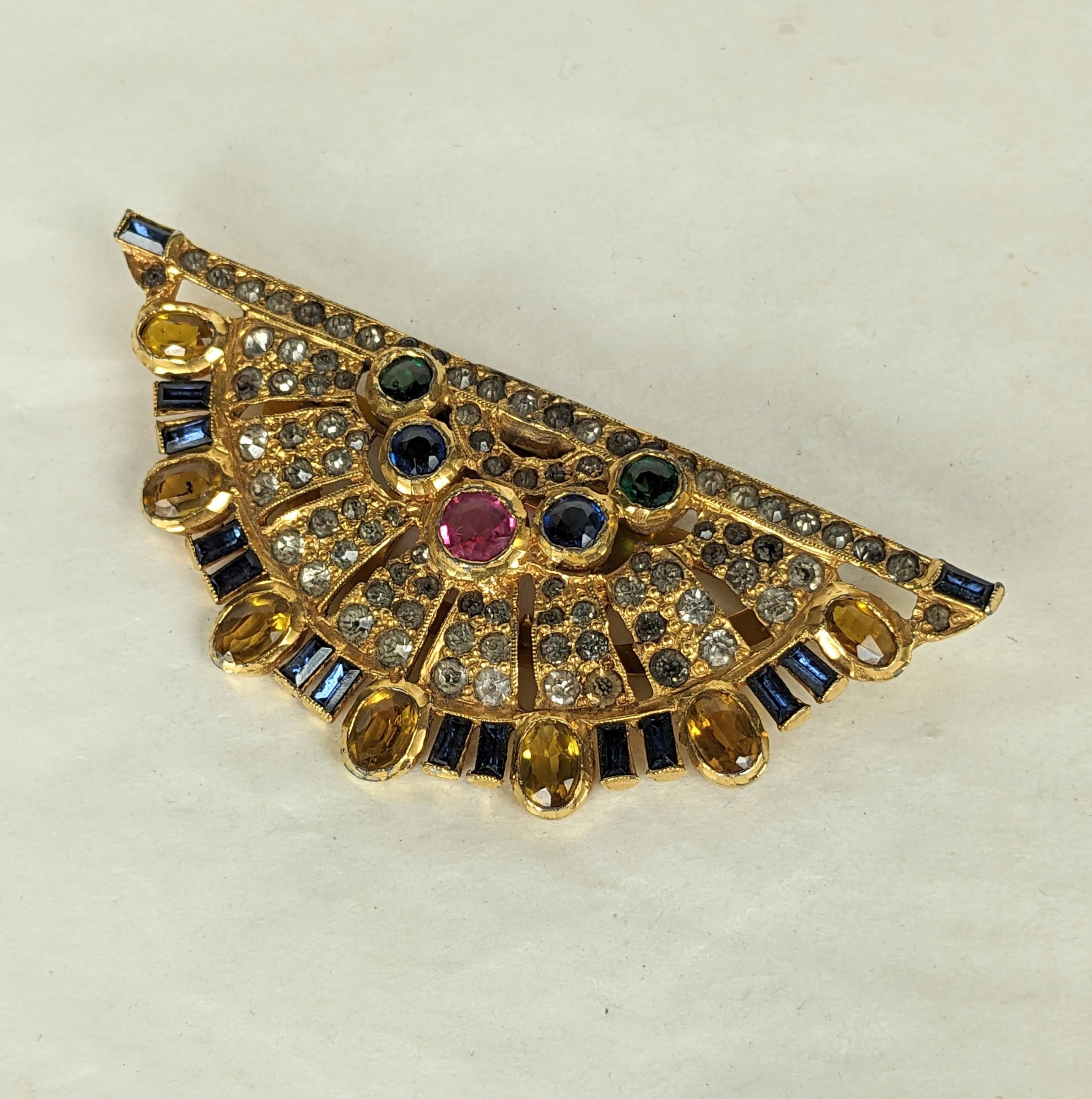 Ralph Derosa intricate Art Deco fan shape lapel clip brooch composed of faux sapphire baguettes, oval and round faceted faux topaz, pink tourmaline and sapphires on a fine crystal rhinestone  pave ground. Signed R Derosa.  Excellent Condition, Clip