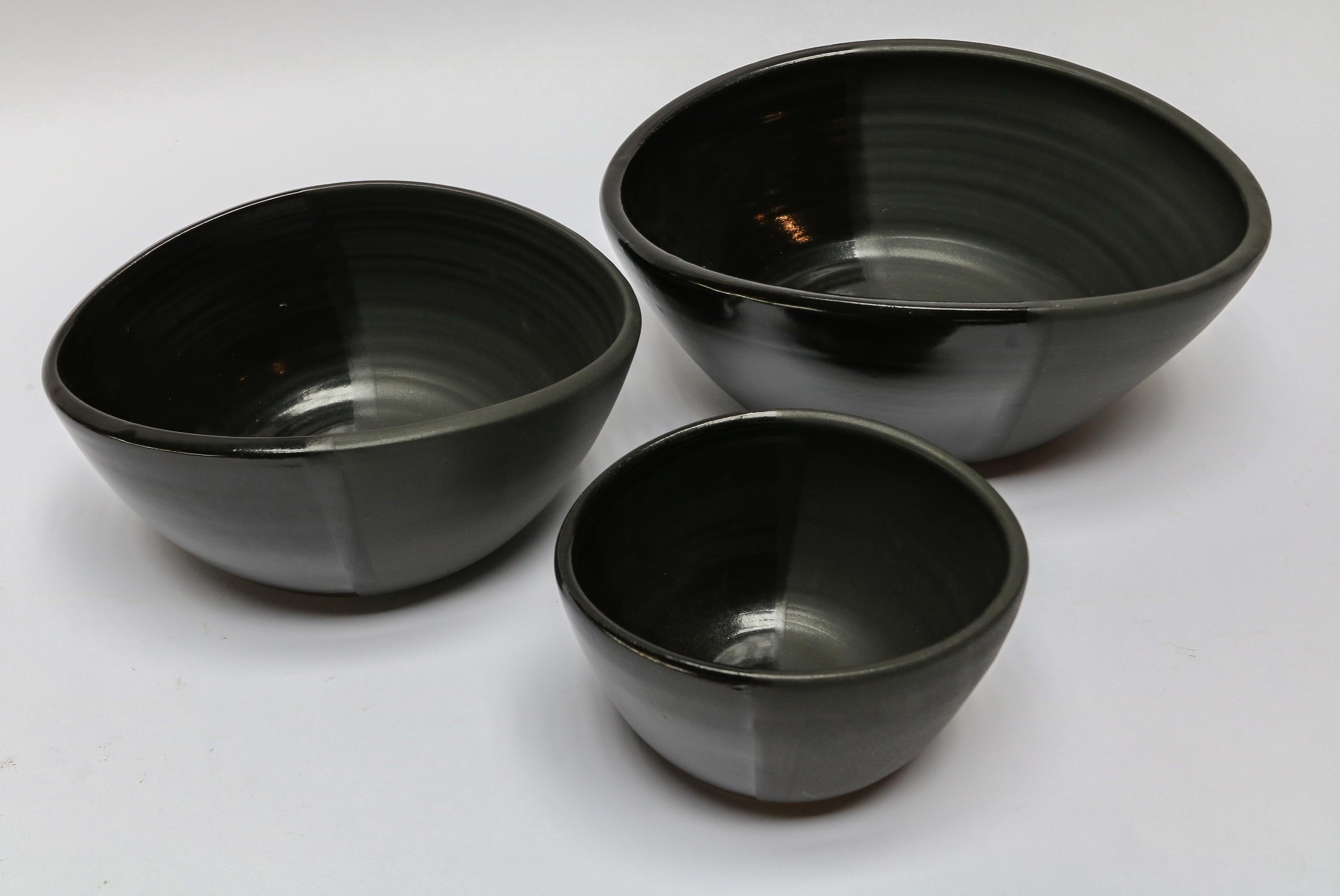 Handmade ceramic Derrick nesting bowls by Style Union Home in noir black. Also available in blanc white.

Small: 7? x 5.5? x 4? H
Medium: 10? x 9? x 4.5? H
Large: 13? x 10.5? x 4.75? H.
