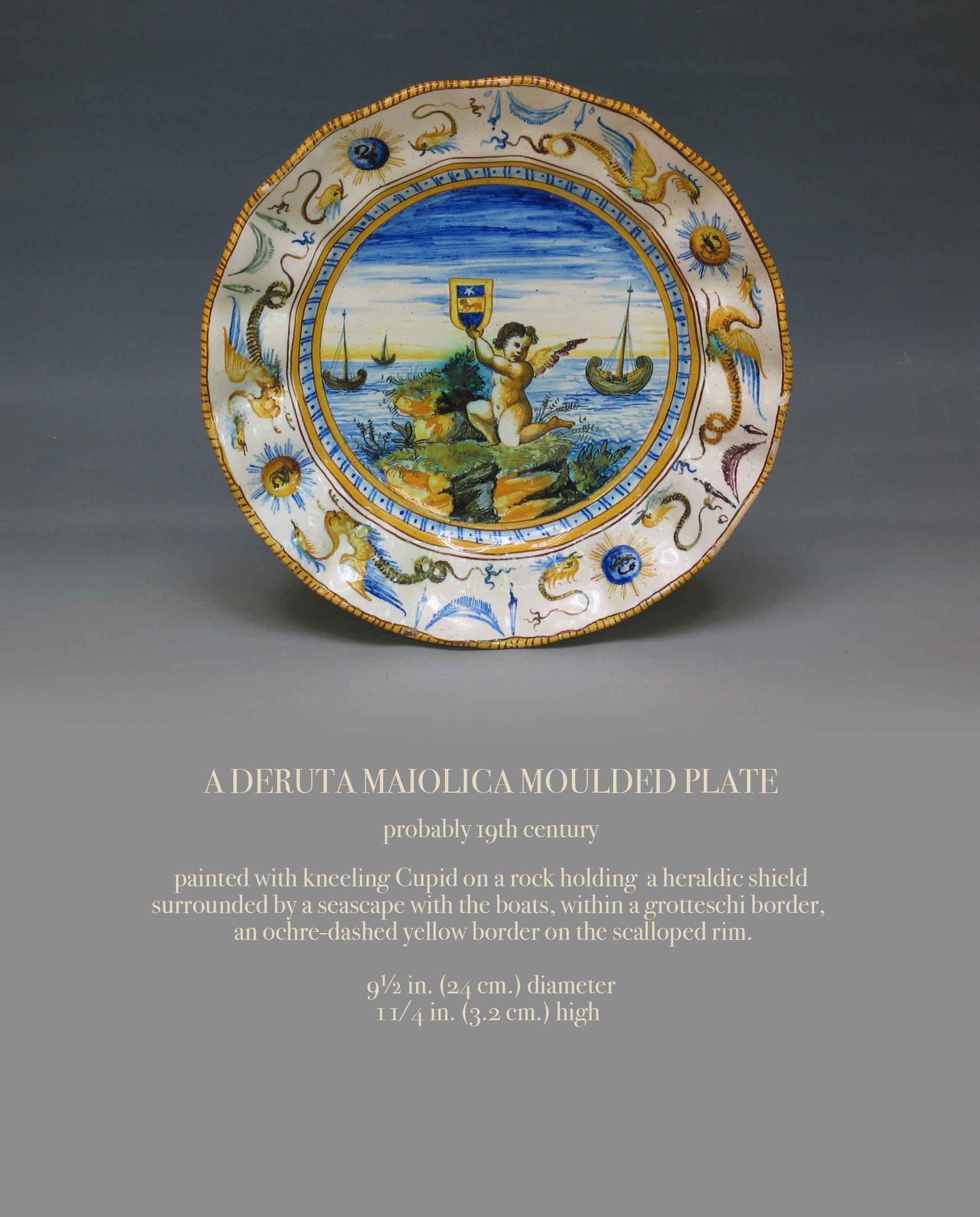 A DERUTA MAIOLICA MOULDED PLATE

Probably 19th Century.

Painted with kneeling Cupid on a rock holding  a heraldic shield surrounded by a seascape with the boats, within a grotteschi border, an ochre-dashed yellow border on the scalloped rim.

9½