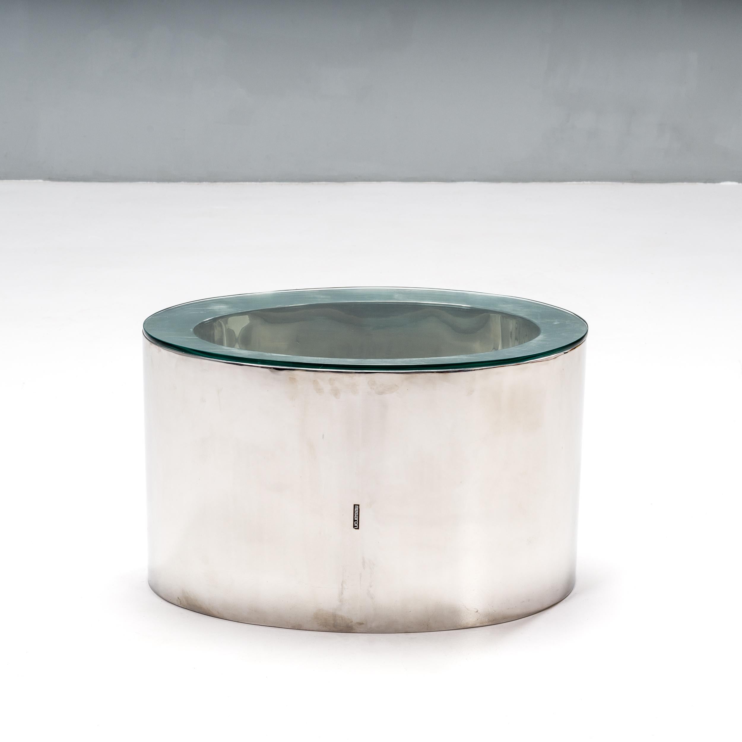 A fantastic example of modern design, the Pebble coffee table was designed by Derya Akdurak for Megaron.

Constructed from a polished chrome base, the table has a smooth, oval shape with a hollowed out centre.

A clear glass top creates the
