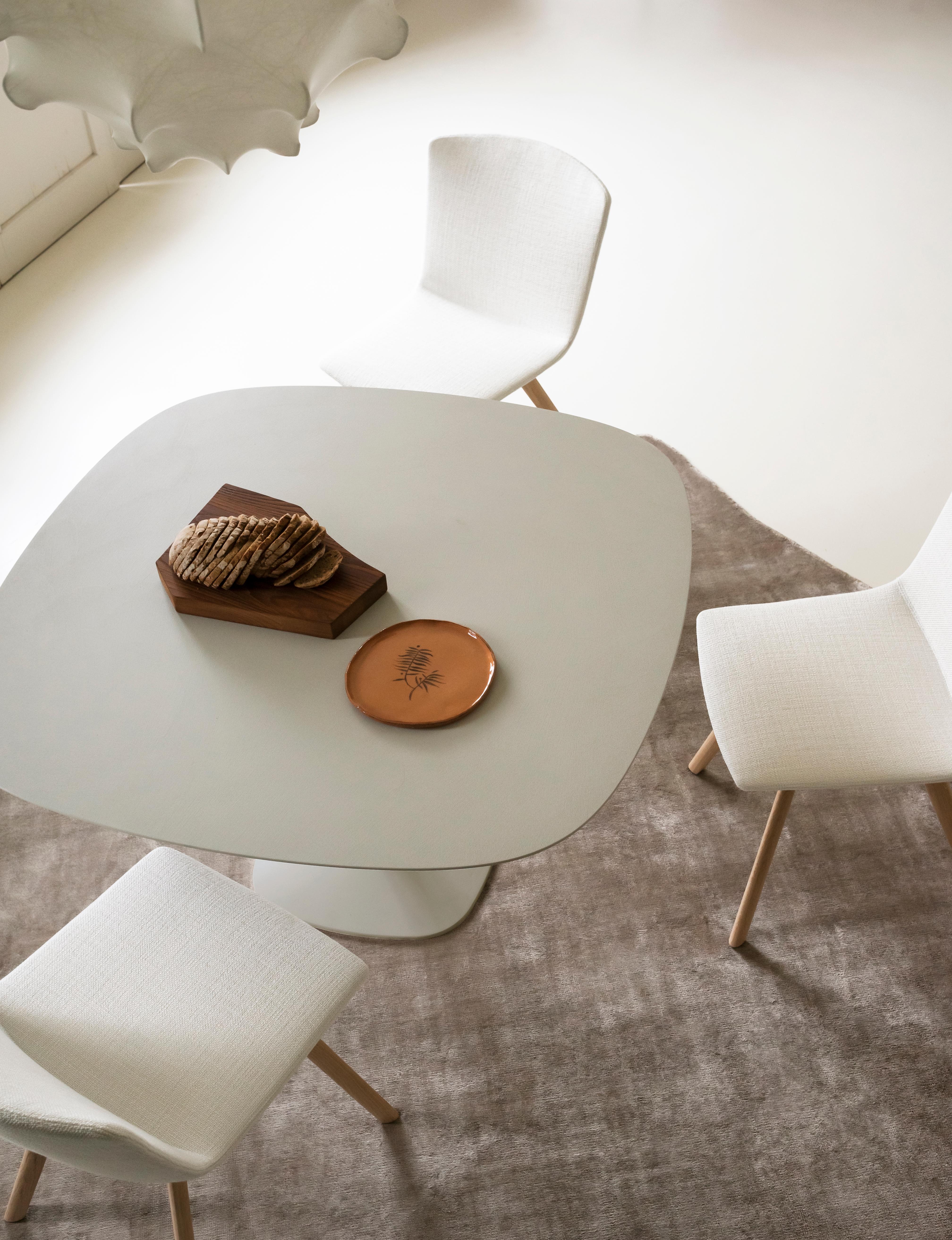 A collection of tables with an essential design and archetypal shapes, with a dual purpose for indoor and outdoor use in both domestic and collective spaces. An almost monolithic, clear presence, a silhouette that stands out in the space connoting