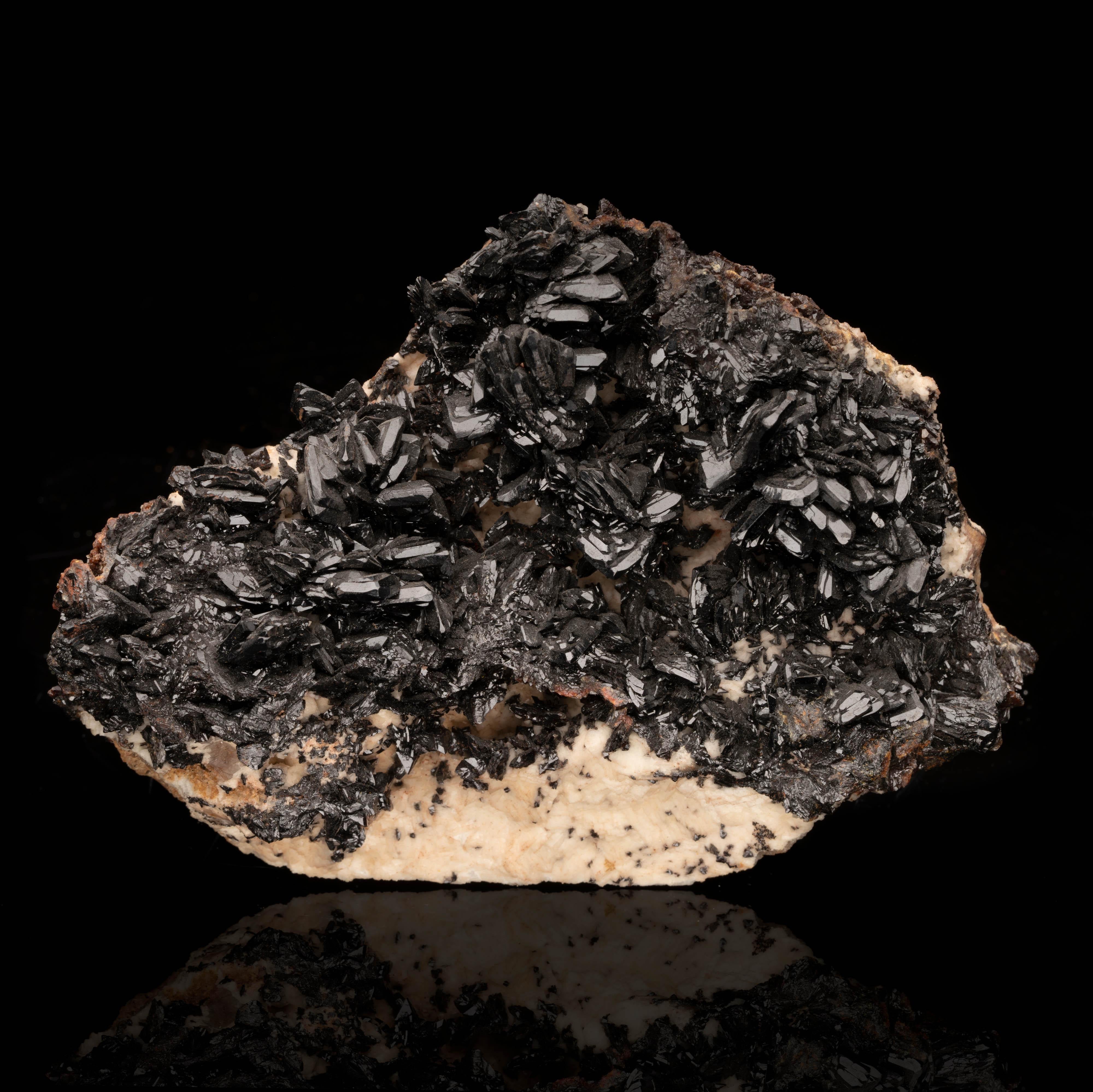 Rare, inky, lustrous, sharply defined descloizite from a pocket mined in the 1970s out of the Tsumeb Mine in the Oshikoto Region of Namibia, the large, fully formed crystals on this excellent collector's specimen pop against a pale matrix. An