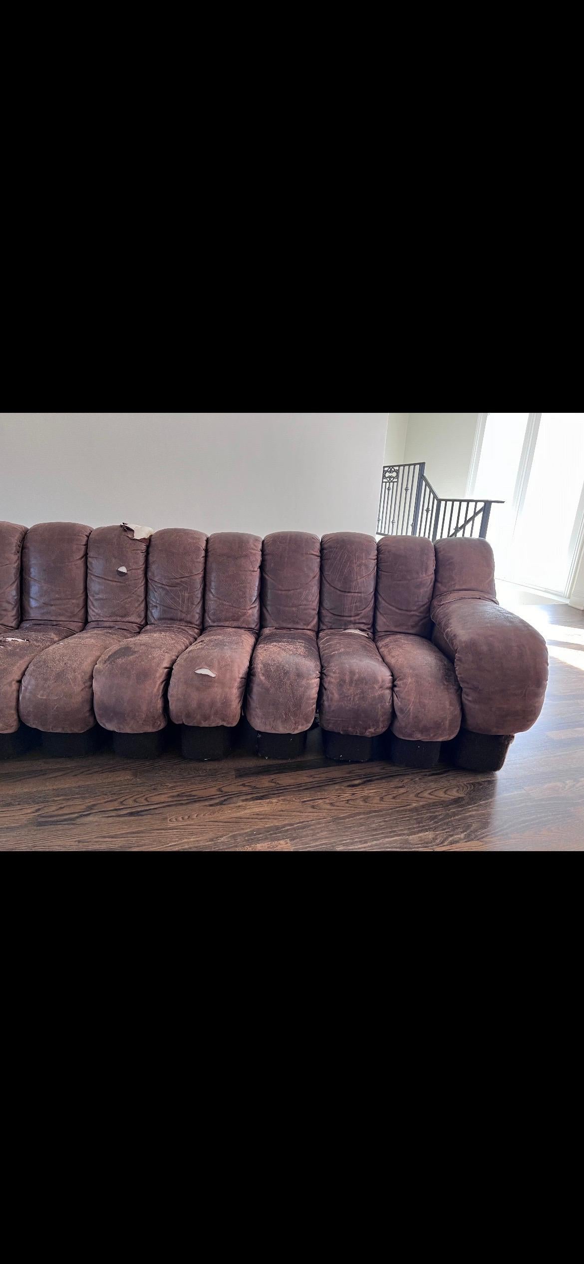 De Sede 600 non stop chocolate brown 18 element sofa, 1970s

Beautiful distressed chocolate brown sofa by De Sede. This item needs to be reupholstered. There are approx 6-8 leather parts that need to be redone. 18 elements.