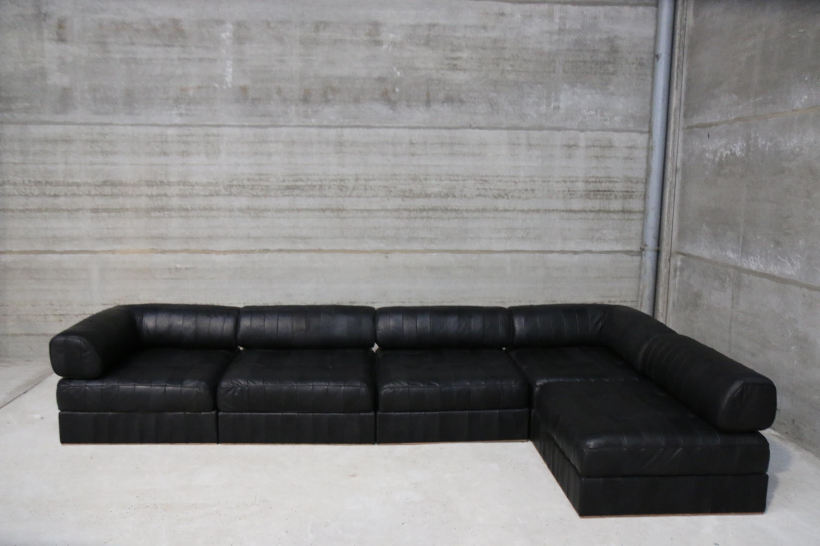 This modular lounge set from Swiss manufacturer De Sede was re-upholstered in our funky vintage studio in Belgium. The leather used for this patchwork is a full grain black leather from European bulls and colored biologically. More then 8000 pieces