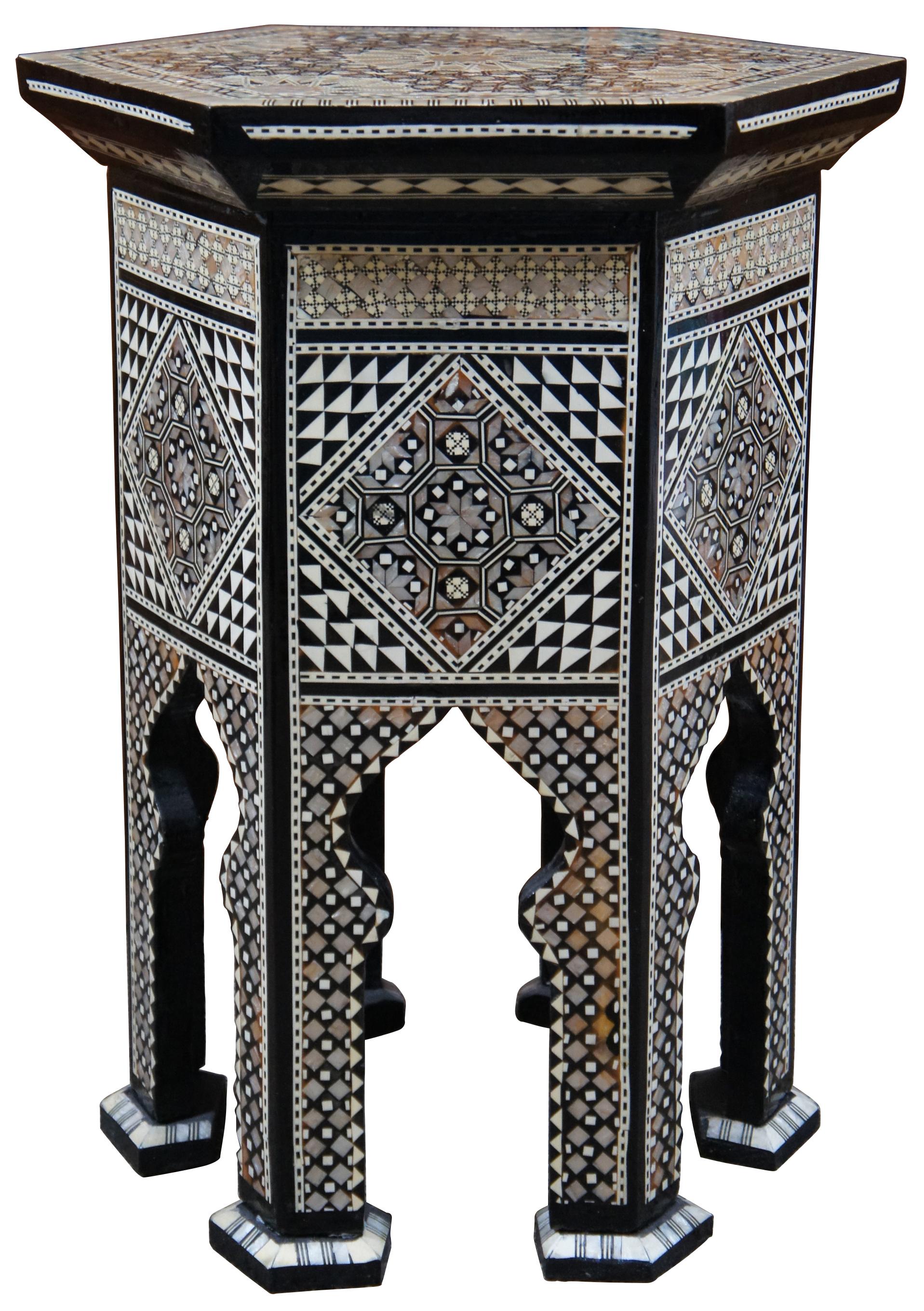 Elegant Moroccan/Moorish style accent table with a black lacquer finish inlaid with mother of pearl designs. The hexagonal top lift off to reveal a red velvet lined compartment. Made in Egypt by Desert Designs.
  