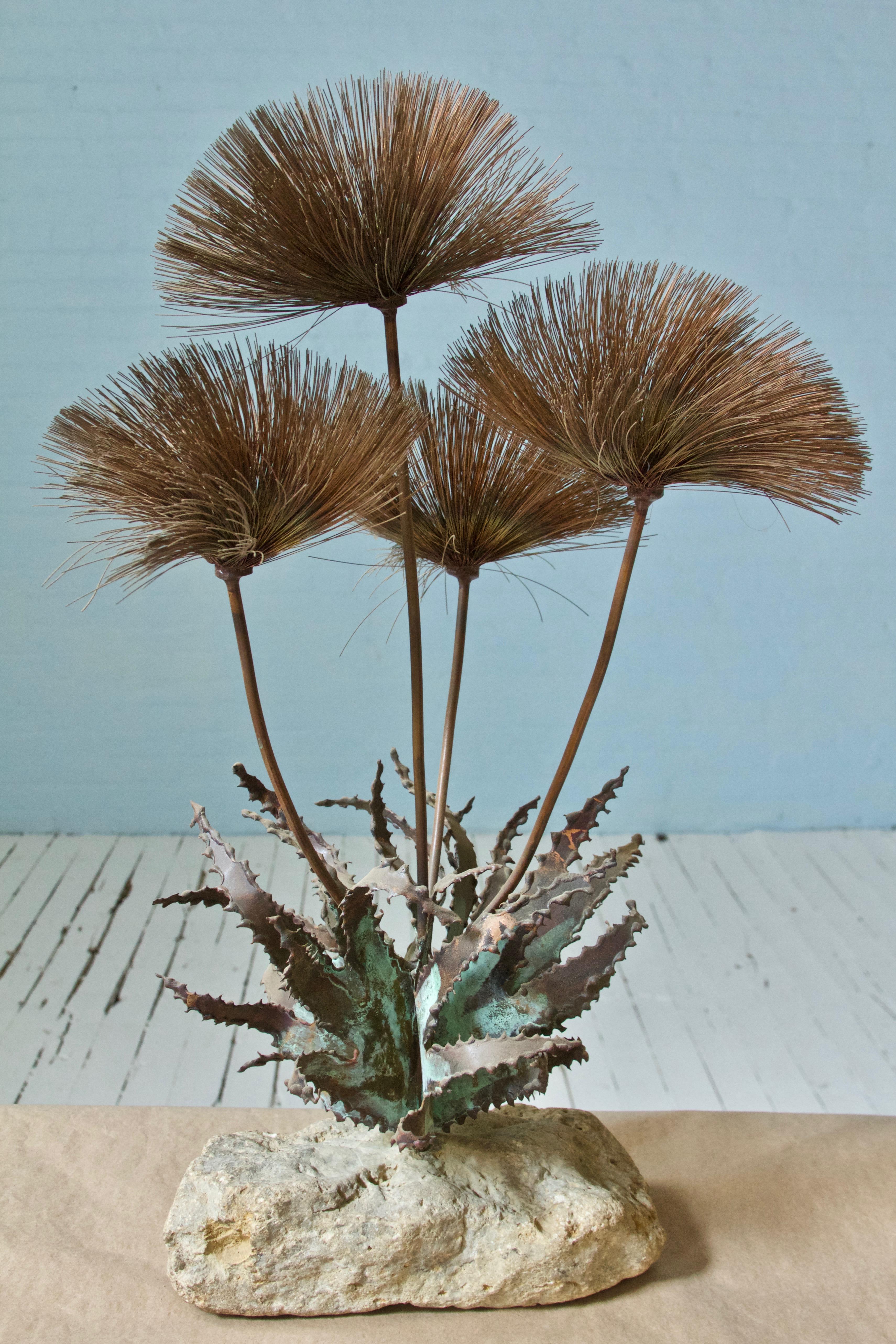 Decorative Jere-style Brutalist desert flowers made of metal brass or copper, mounted to a solid stone base. Sculpture attributed to artist John Steck.