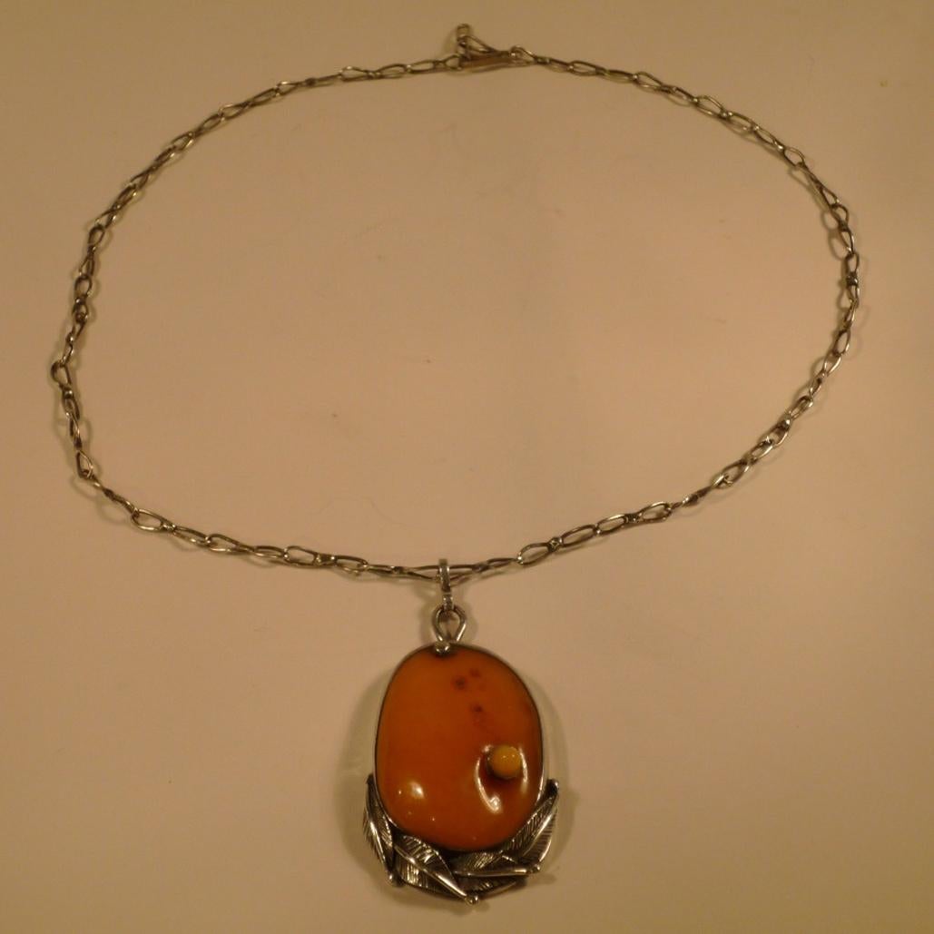Handmade amber jewellery set in silver, 
Length of the matching handmade chain 63 cm, 
no hallmark
This material mix of silver and amber has been very popular especially in the Scandinavian countries and the other countries bordering the Baltic Sea