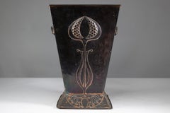 Robert Hilton. An Arts & Crafts copper coal bucket with a single flower in seed.