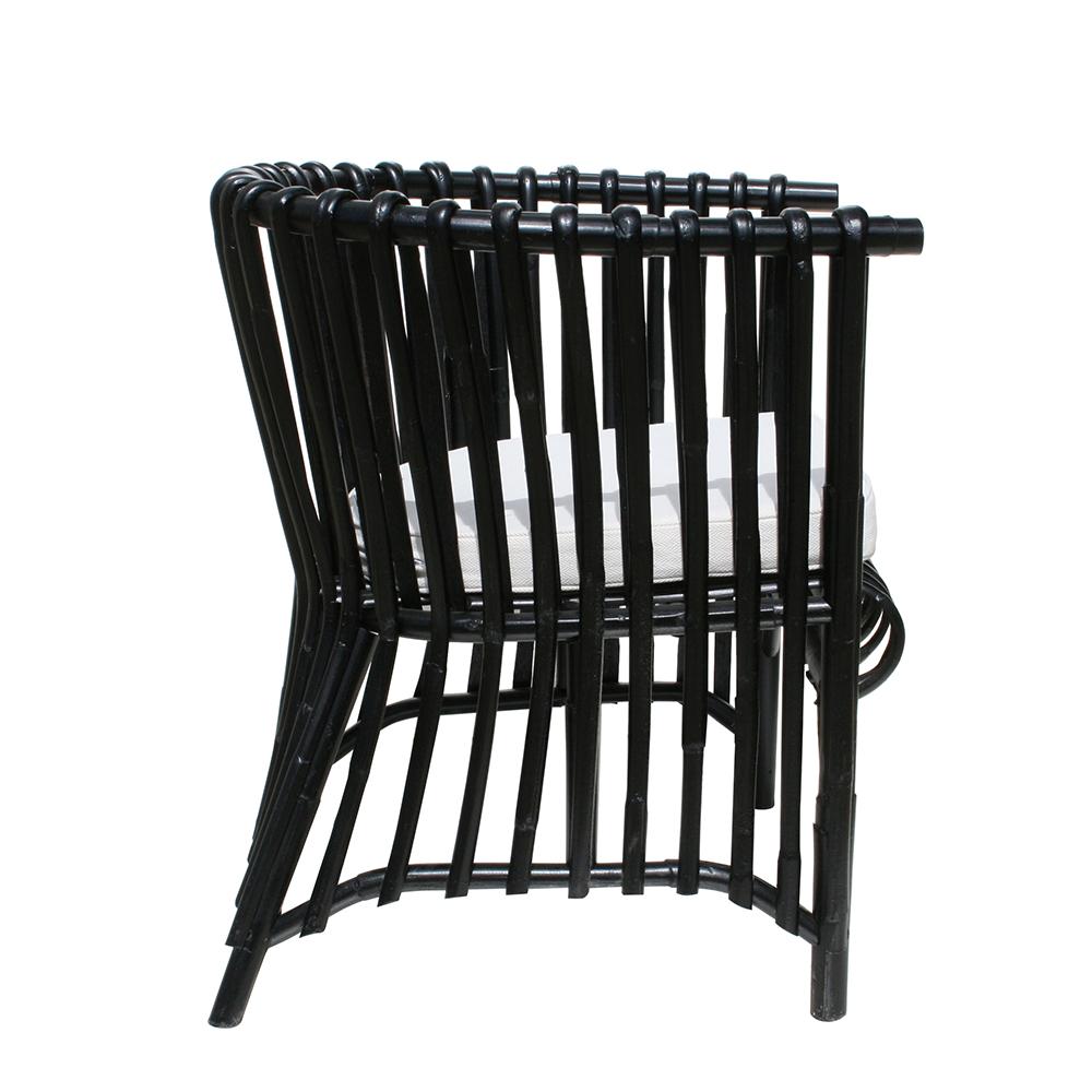 Black rattan armchair, with amazing and welcoming shape and airy structure.