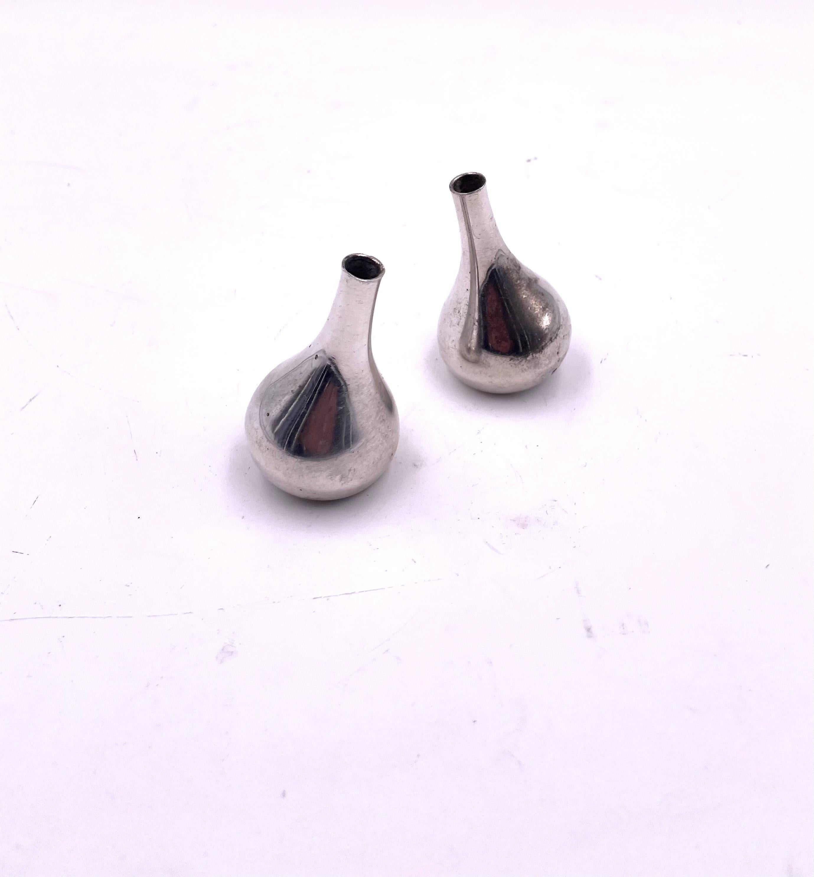 Beautiful pair of Dansk tilting silver-plated teardrop candleholders in great vintage condition. This piece was designed by Jens Quistgaard and is true to the Mid-Century Modern aesthetic. They were crafted by Dansk made in France. The piece can be