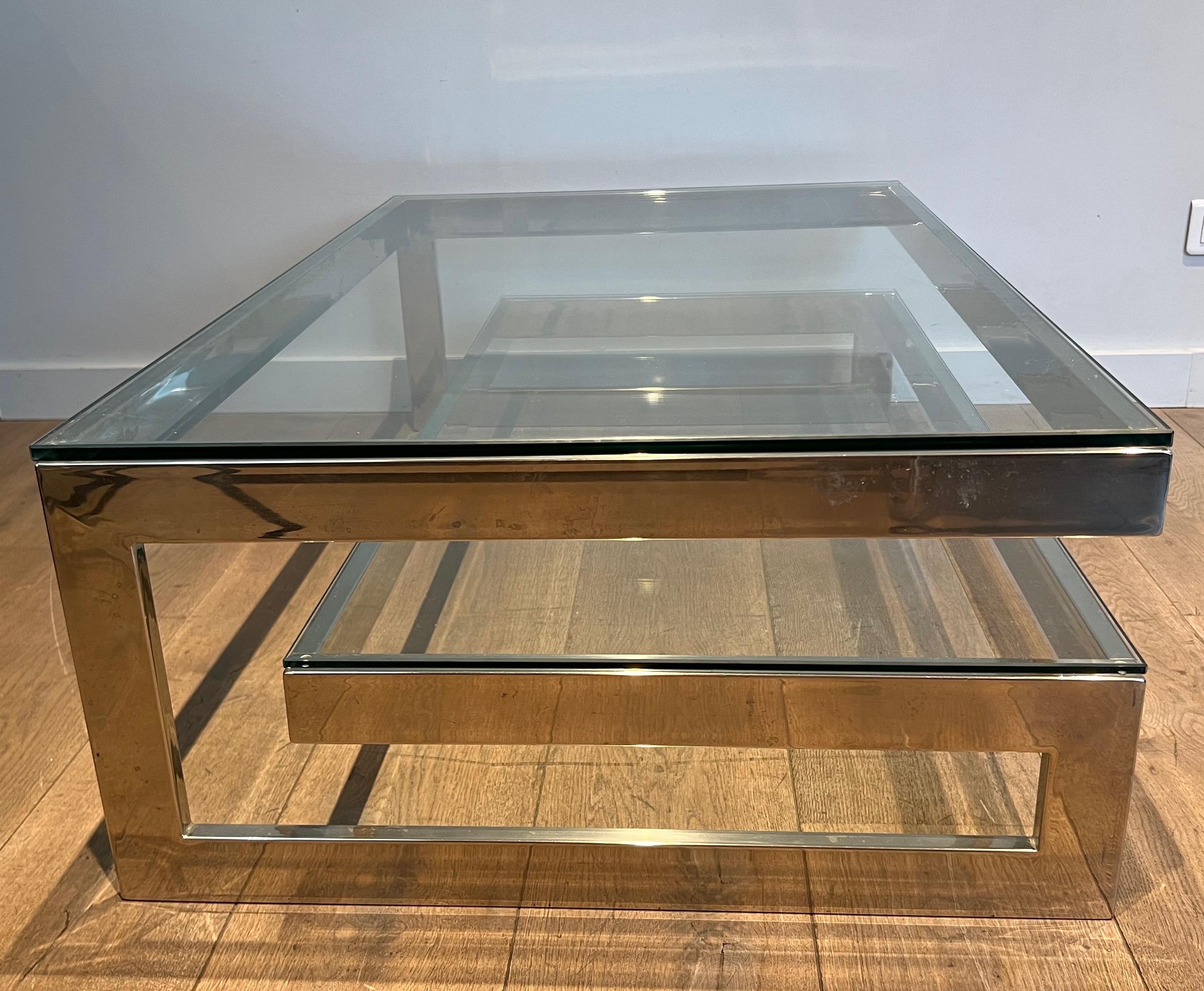 This design coffee table is made of chrome with 2 thick glass shelves. This is a French work, circa 1970.