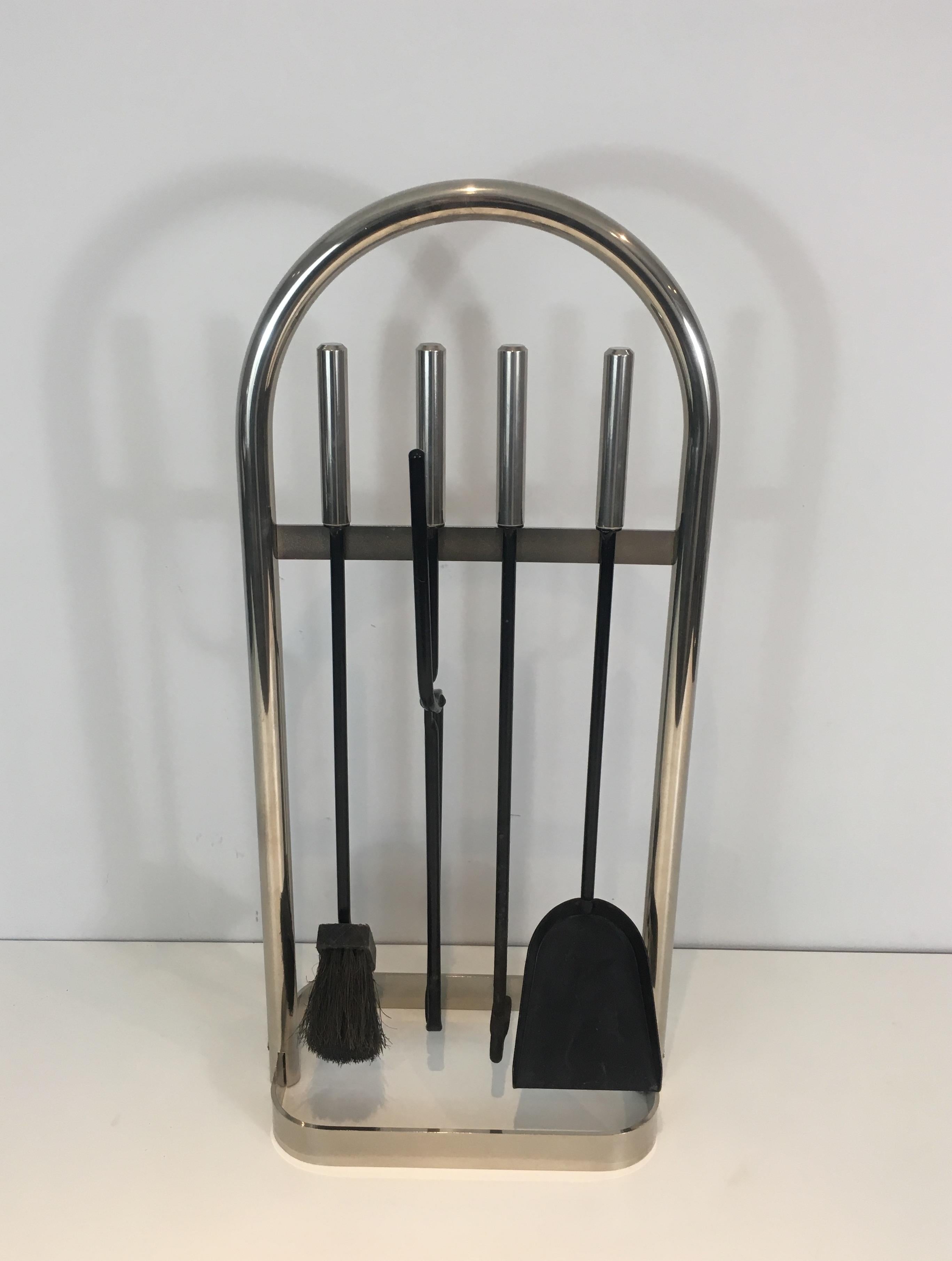 This fire place tools on stand is made of brass and lacquered iron. It has a nice design, very simple. This is a French work, circa 1970.