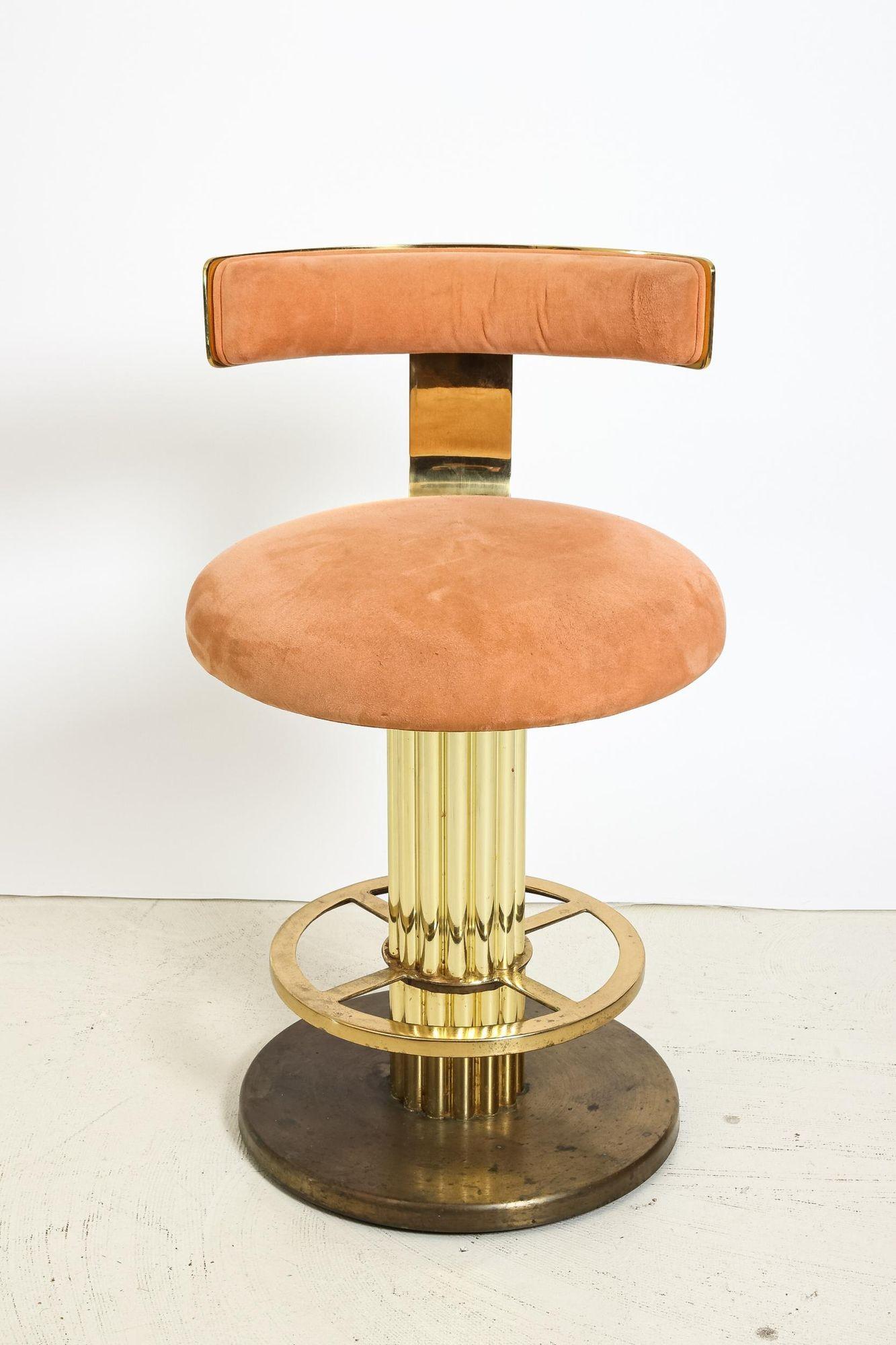 Glamorous gold and pink suede counter or bar stools manufactured by Design for Leisure in the 1980s. An opulent style with Art Deco influence, these stools feature rounded seats and fluted base with footrest. Stools have an automatic return to a
