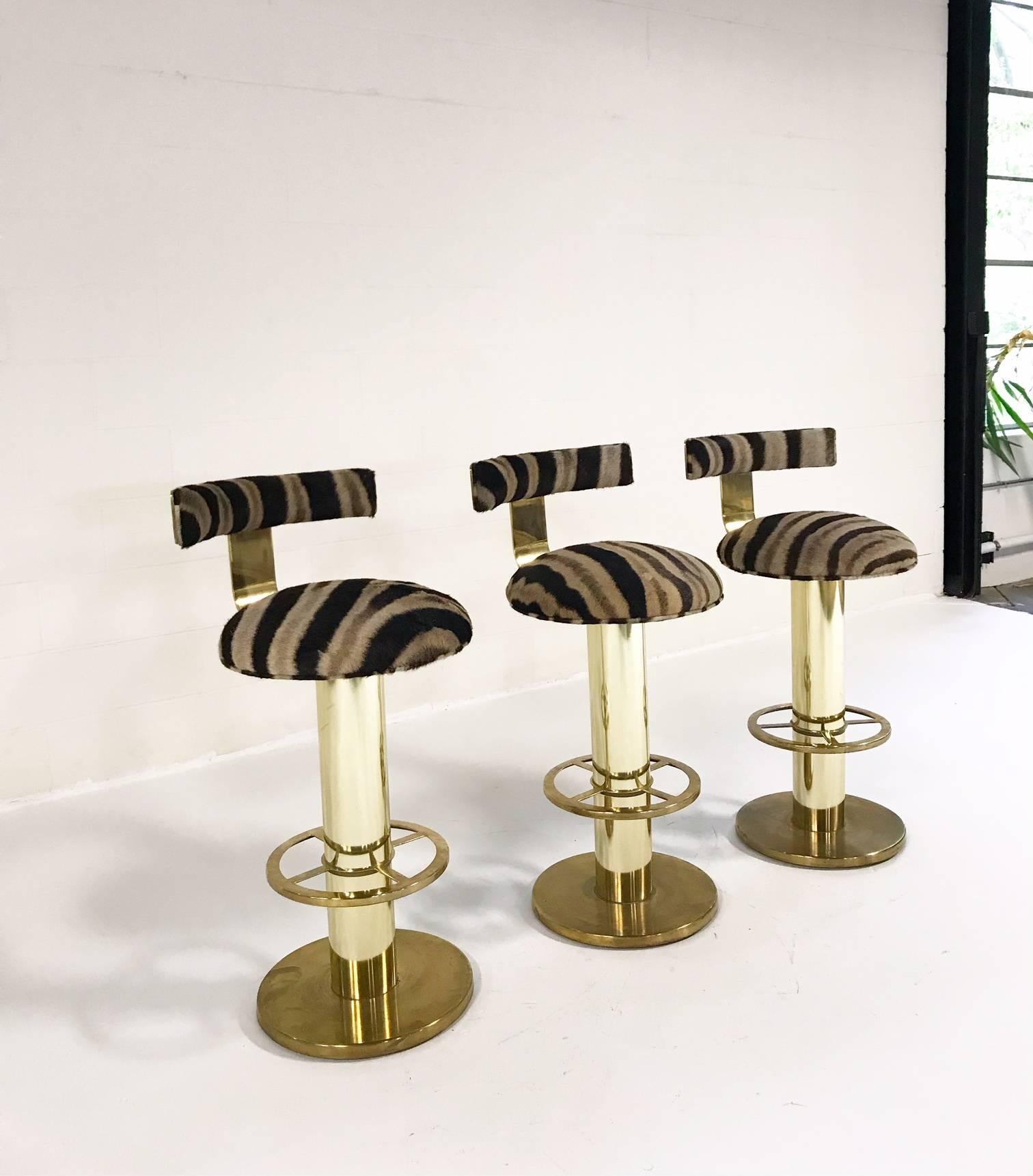 The ultimate bar stools! These one-of-a-kind Design For Leisure brass-plated bar stools are made for a rock and roll space. Completely restored in our zebra hides, these stools ooze Hollywood glam. Did we mention each ways almost 70 pounds! Damn