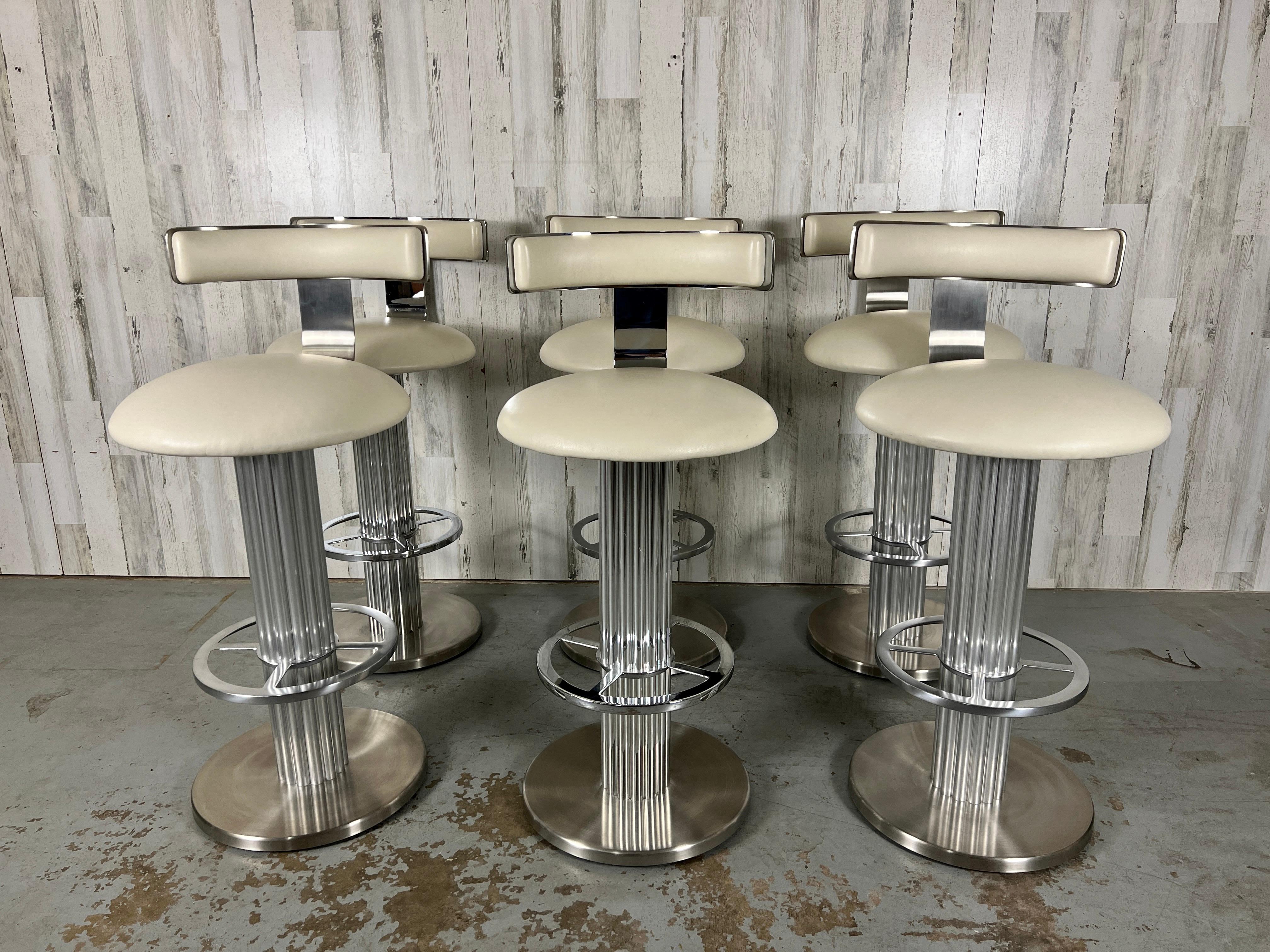 Design for Leisure brushed stainless steel swivel bar stools- set of 6. Very high quality metal & original off white leather upholstery make these stools look very luxurious.
