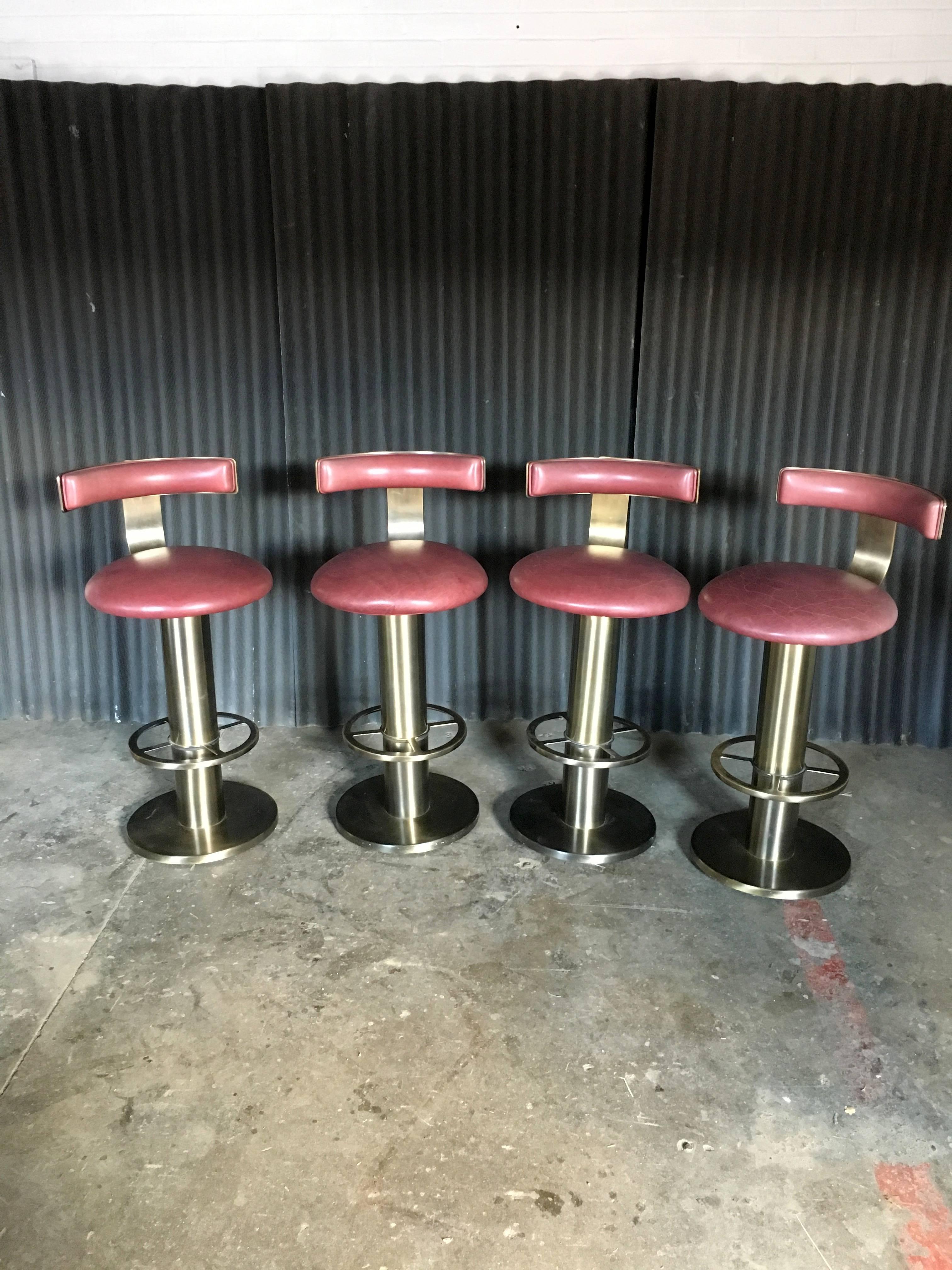 The ultimate barstool and a group of four identical ones at that!
The seats and back are in perfect condition and the brass plating is just fabulous. To me, they appear more bronze than brass.
We love getting these barstools in and are thrilled