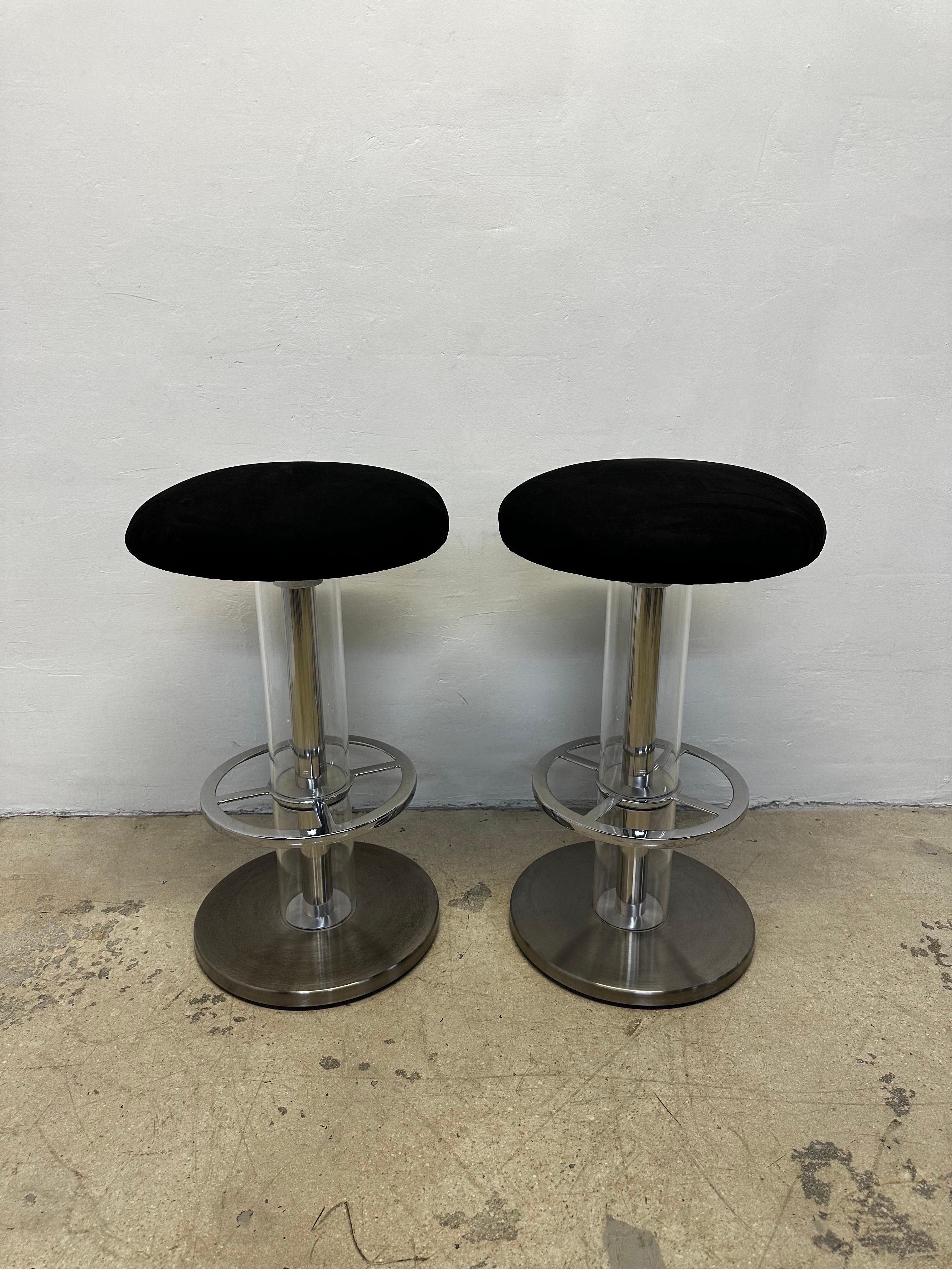 Pair of Design For Leisure bar stools with black ultra suede swivel seats supported by a steel frame base with clear acrylic tubes.