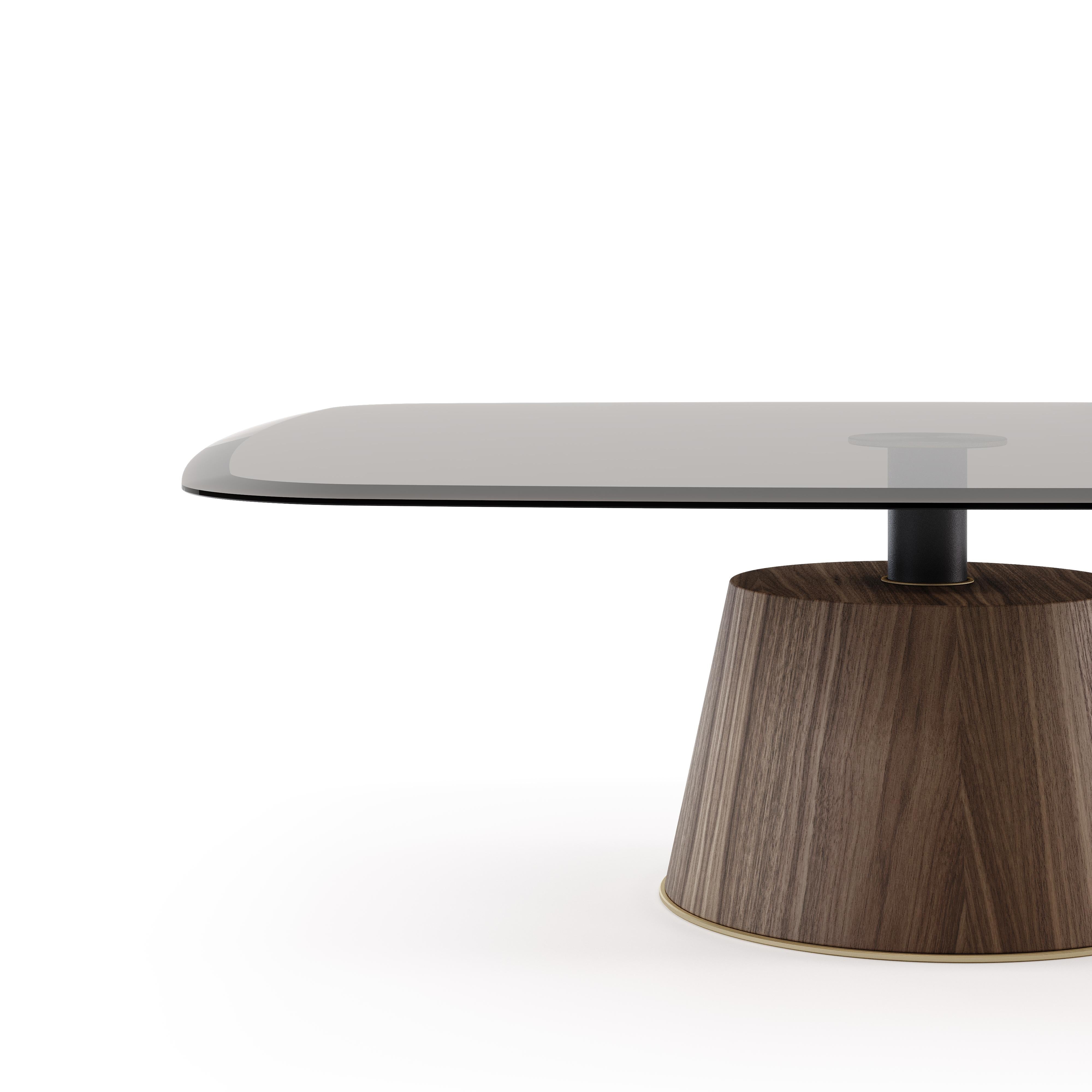 A superb table with a cozy style, generous shapes, and curvaceous design. The round glass top is welded to the conical wood base serving for various functions that can be included in both domestic settings and public venues. Along the piece, you