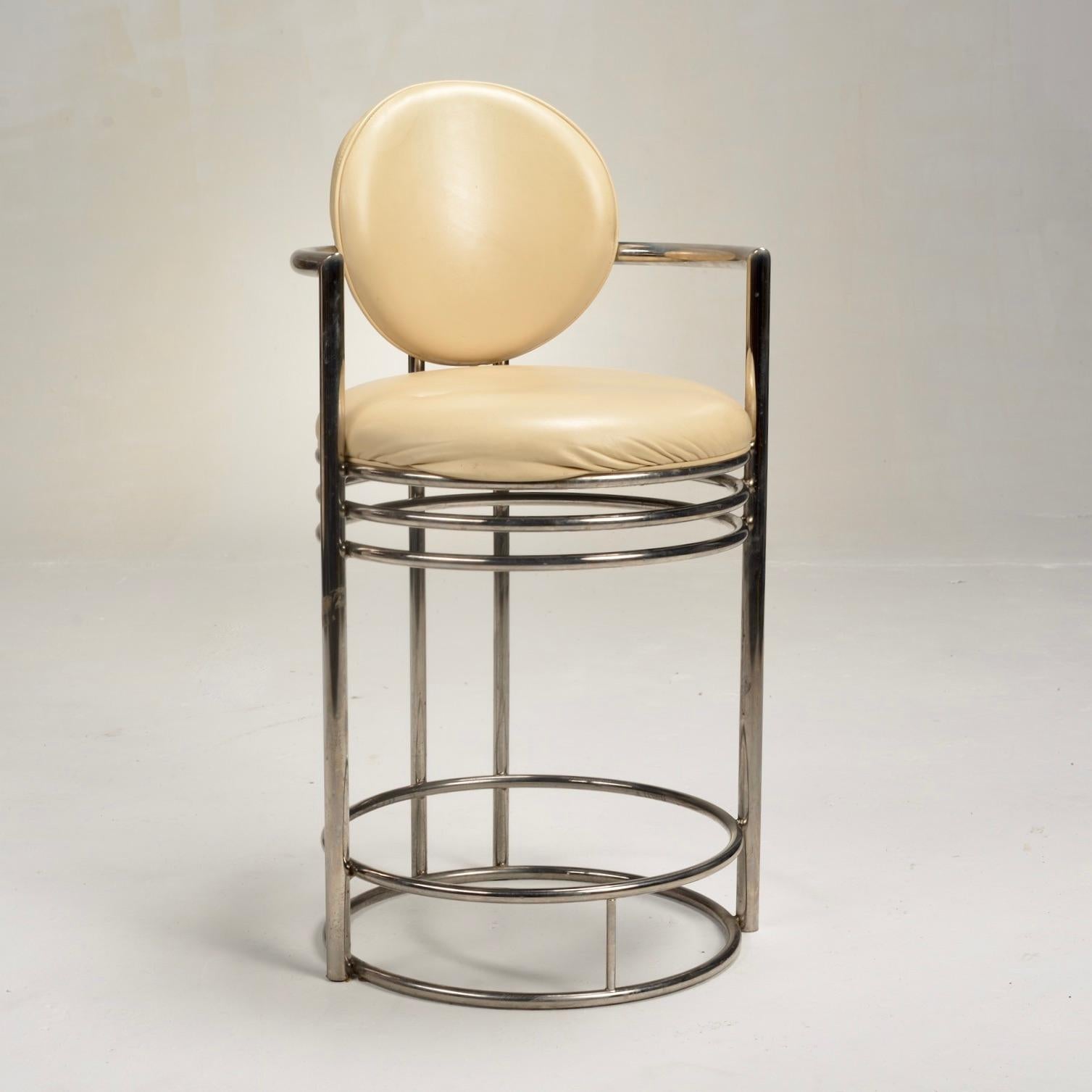 Art Deco revival modern bar stool with nude leather cushioned seat and back rest on a tubular steel base with arms. Designed and manufactured be Design Institute America c. 1980's. 