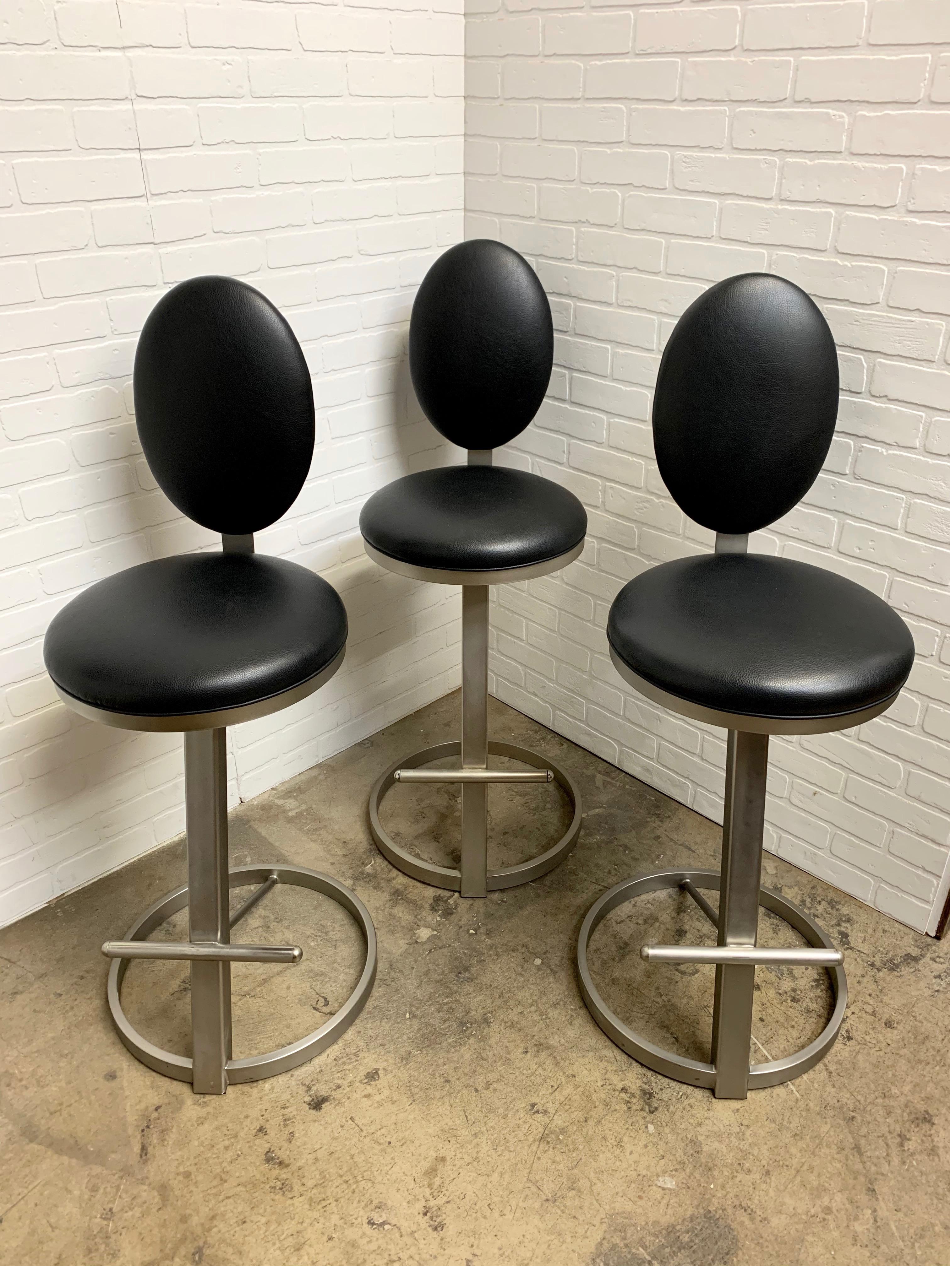 Silver steel with black textured vinyl seat and back in the postmodern design 
They have a swivel return so that they are always center for DIA.
