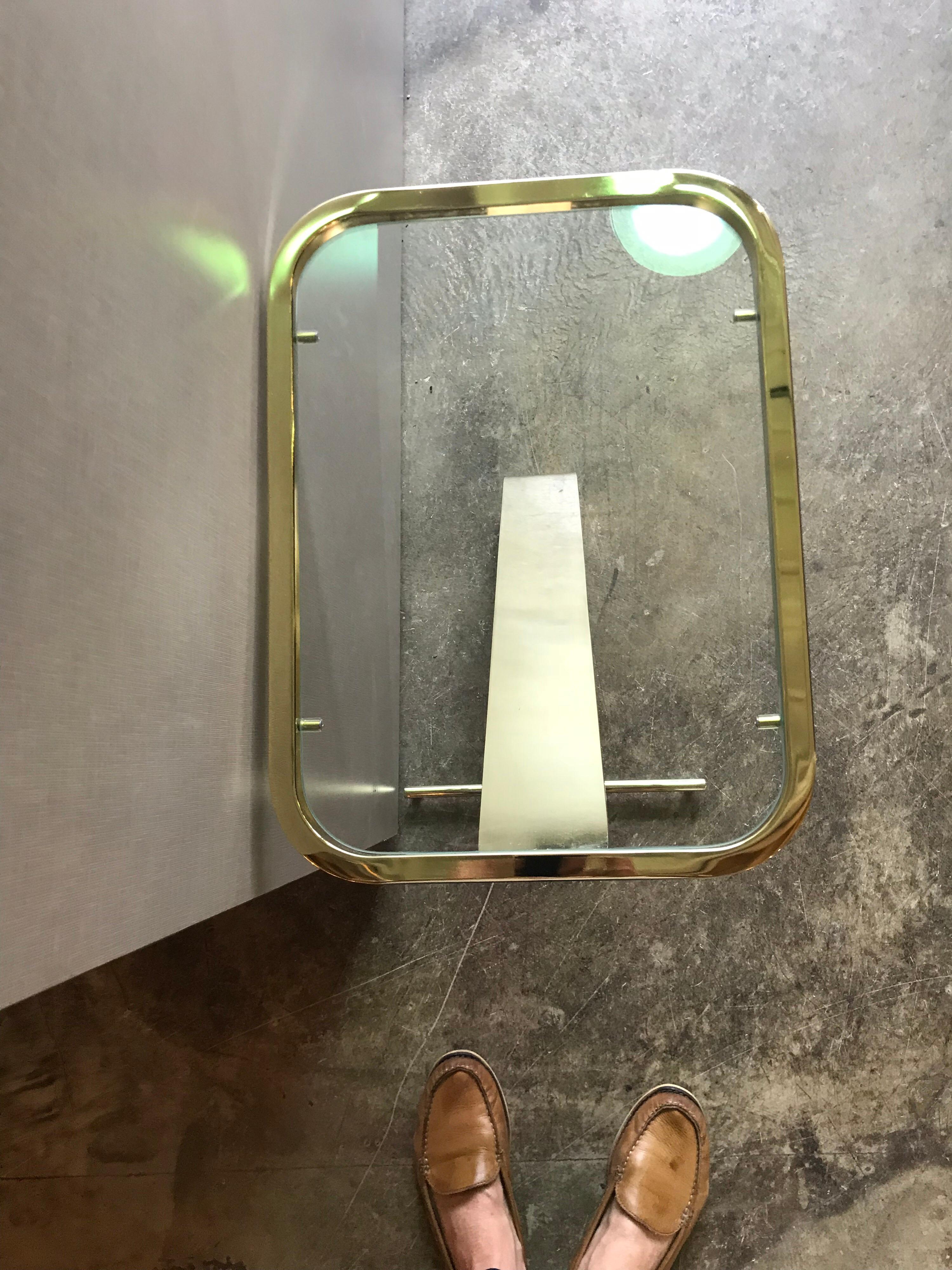 This is a brass and glass small side table by the Design Institute of America. Its probably from the 1970s-1980s and is in great condition.