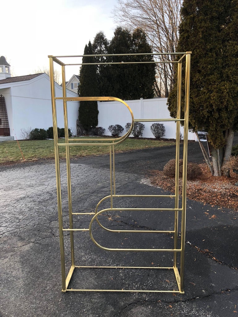 
Design Institute of America brass etagere. Elegant Hollywood Regency style piece. There are eight glass shelves of various sizes. We do have the glass, they show in the last few photos. . Measures: 42