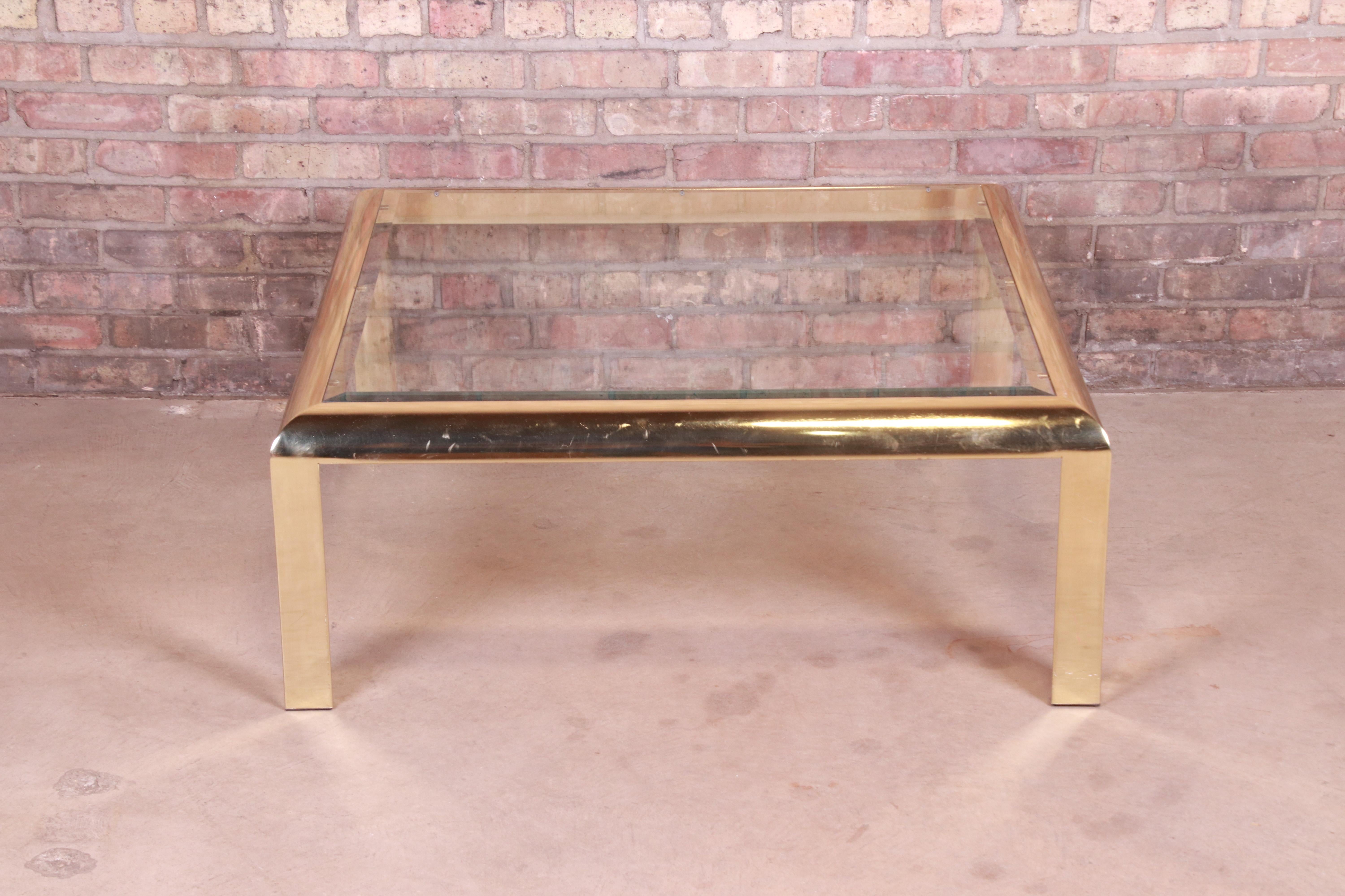 A gorgeous Milo Baughman style modern Hollywood Regency coffee or cocktail table.

By the Design Institute of America,

USA, 1984

Brass frame with beveled glass top.

Measures: 38.5