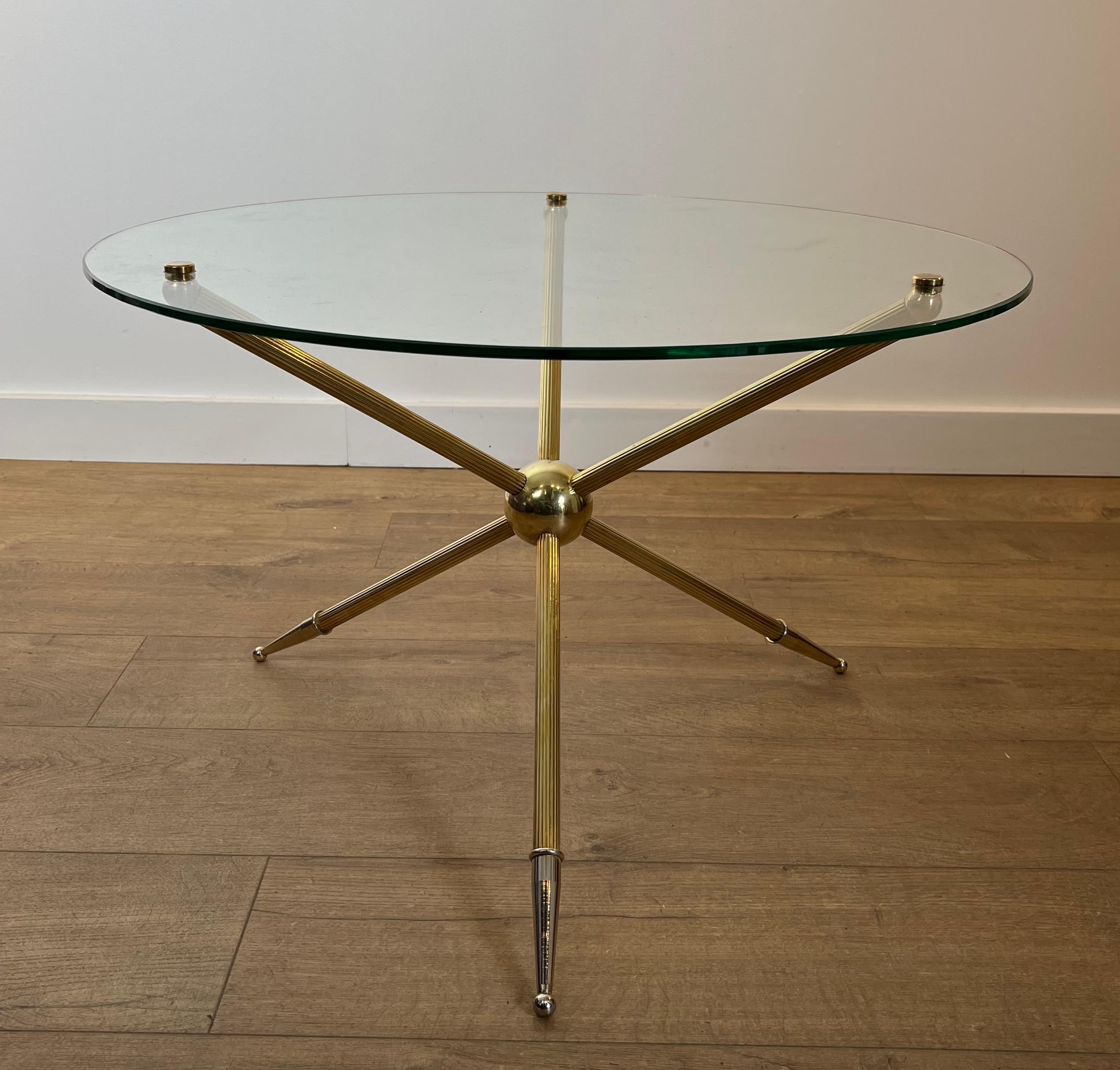 This nice design round tripode coffee table is made of brass with a glass top. This is a French work. Circa 1970