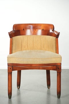 Design side/desk chair with a wooden frame and yellow fabric upholstery
