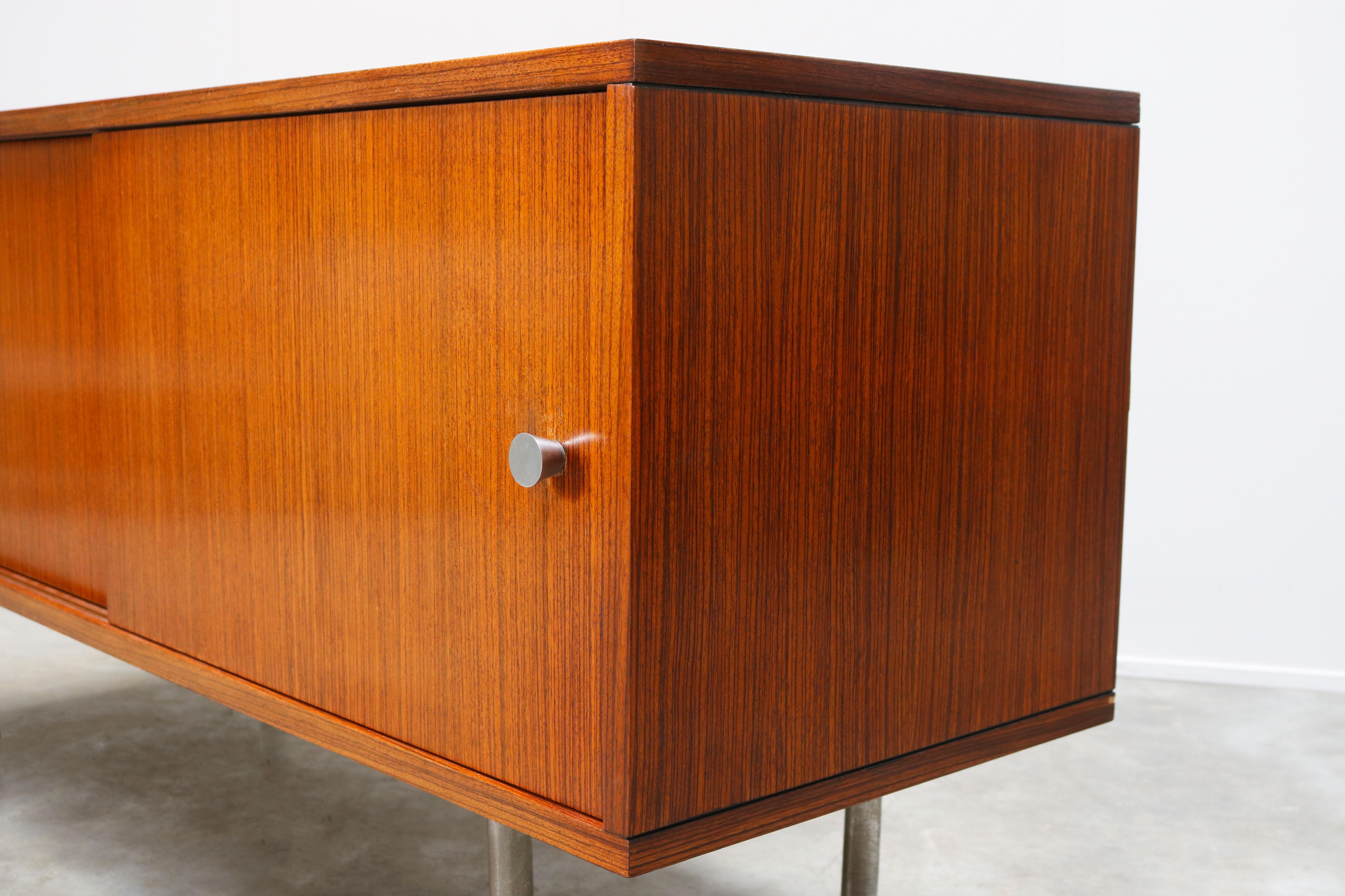Minimalist modernist design sideboard / credenza by Belgian designer Alfred Hendrickx for Belform. This is a very rare small model of his Office series and looks amazing on the chrome feet. The sideboard has 2 sliding doors with aluminum grips and