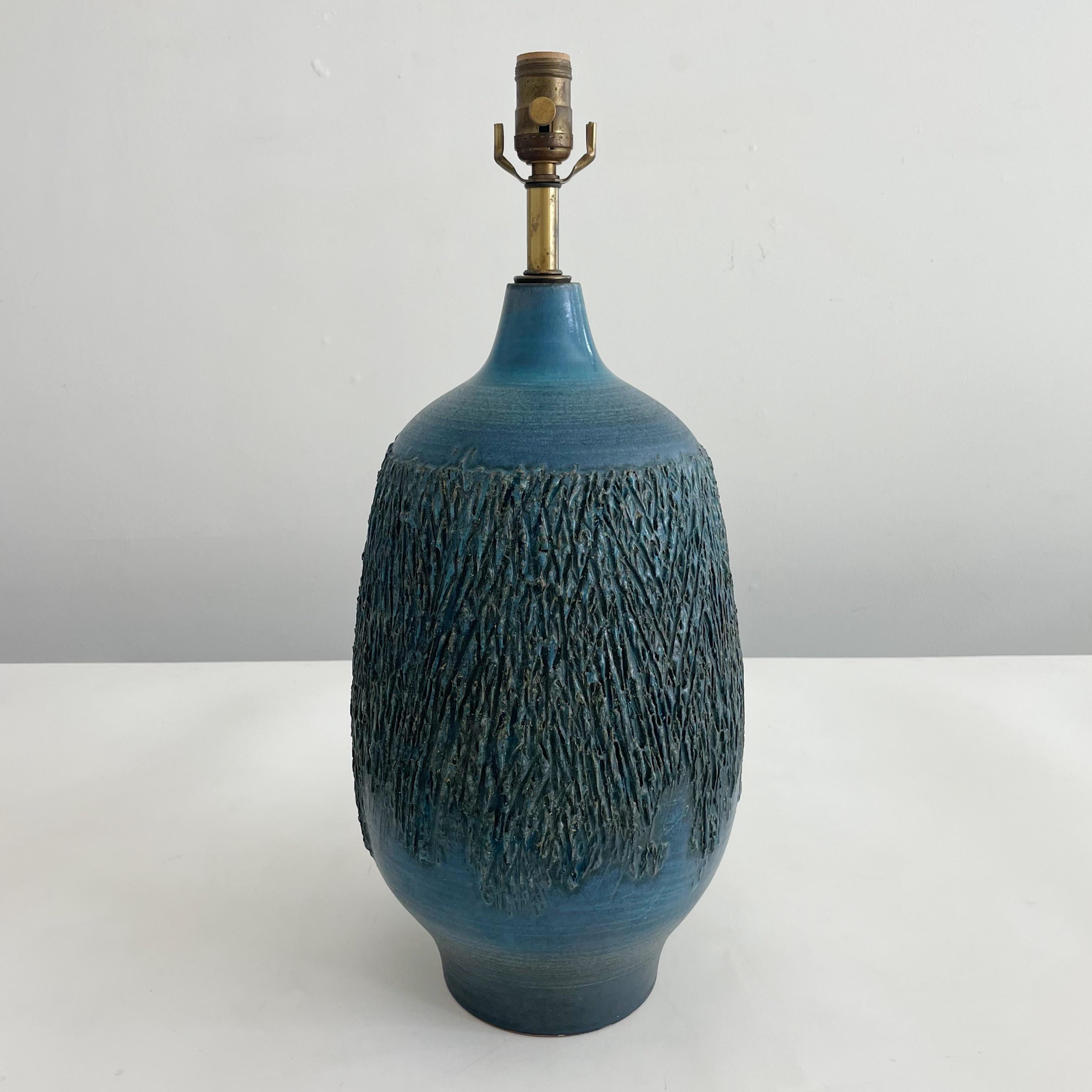 Midcentury hand-thrown stoneware Studio Pottery table lamp glazed in blue studio by Design Technics. Stunning graffito abstract design around the lamp. Marked with the Design Technics applied cypher above the cord exit. Sold without lampshade.

Up