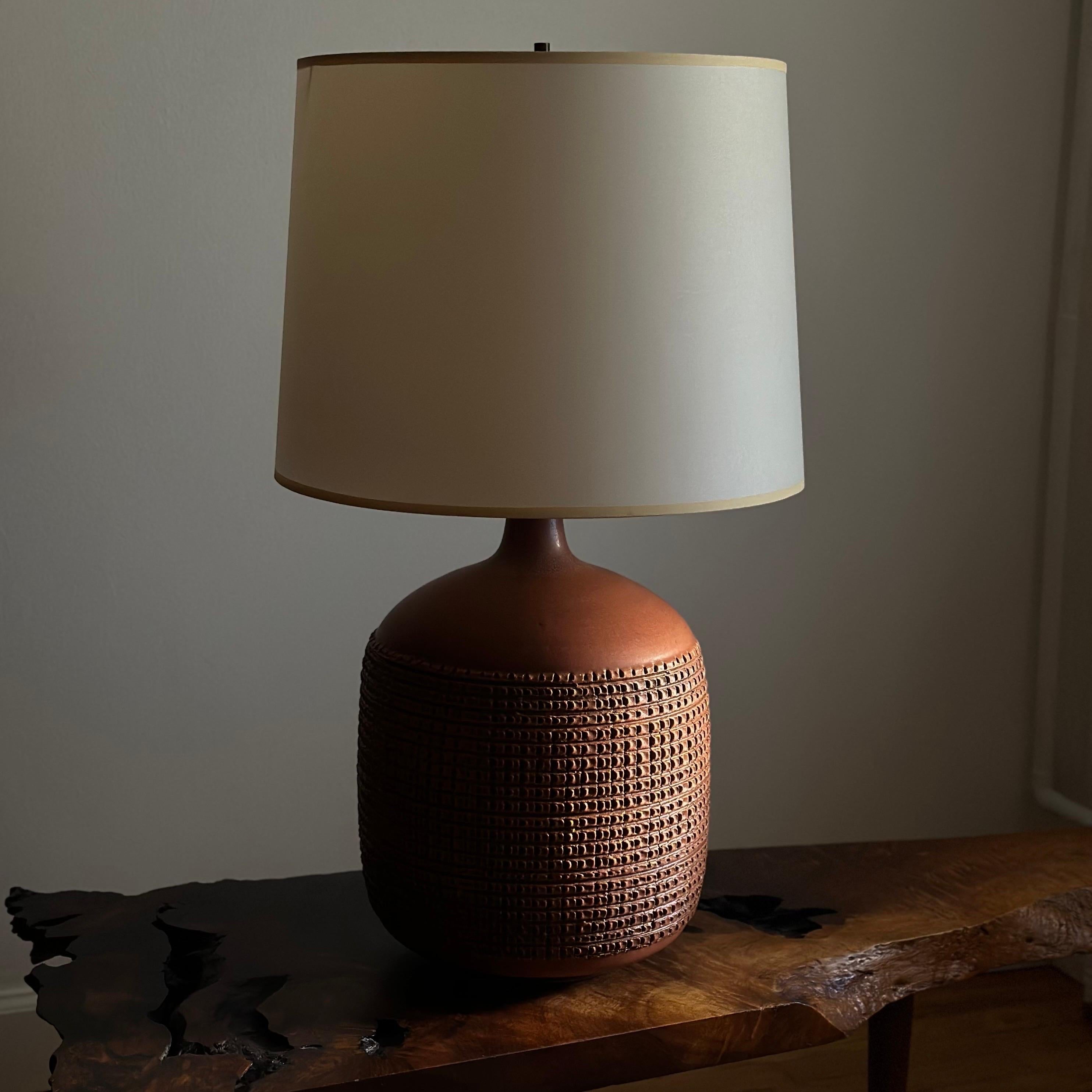 Hand thrown ceramic table lamp with a deeply incised crosshatch pattern designed by Lee Rosen for Design Technics. Signed to the rear with the 
