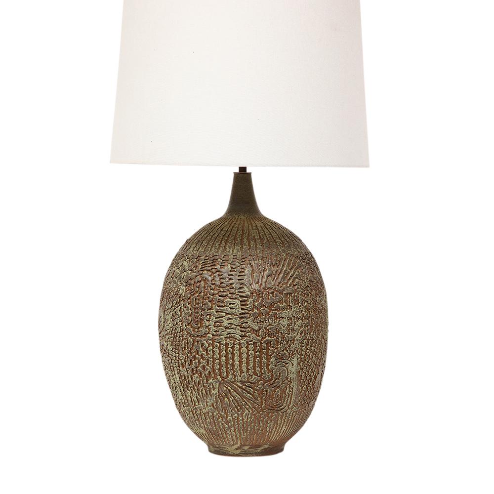 Design Technics Lamp, Pottery, Abstract, Sgraffito, Olive, Red, Signed. The round shape features an intricate olive tone textured sgraffito pattern over a light brick red glazed terra cota body. Signed with impressed maker's mark above the cord's