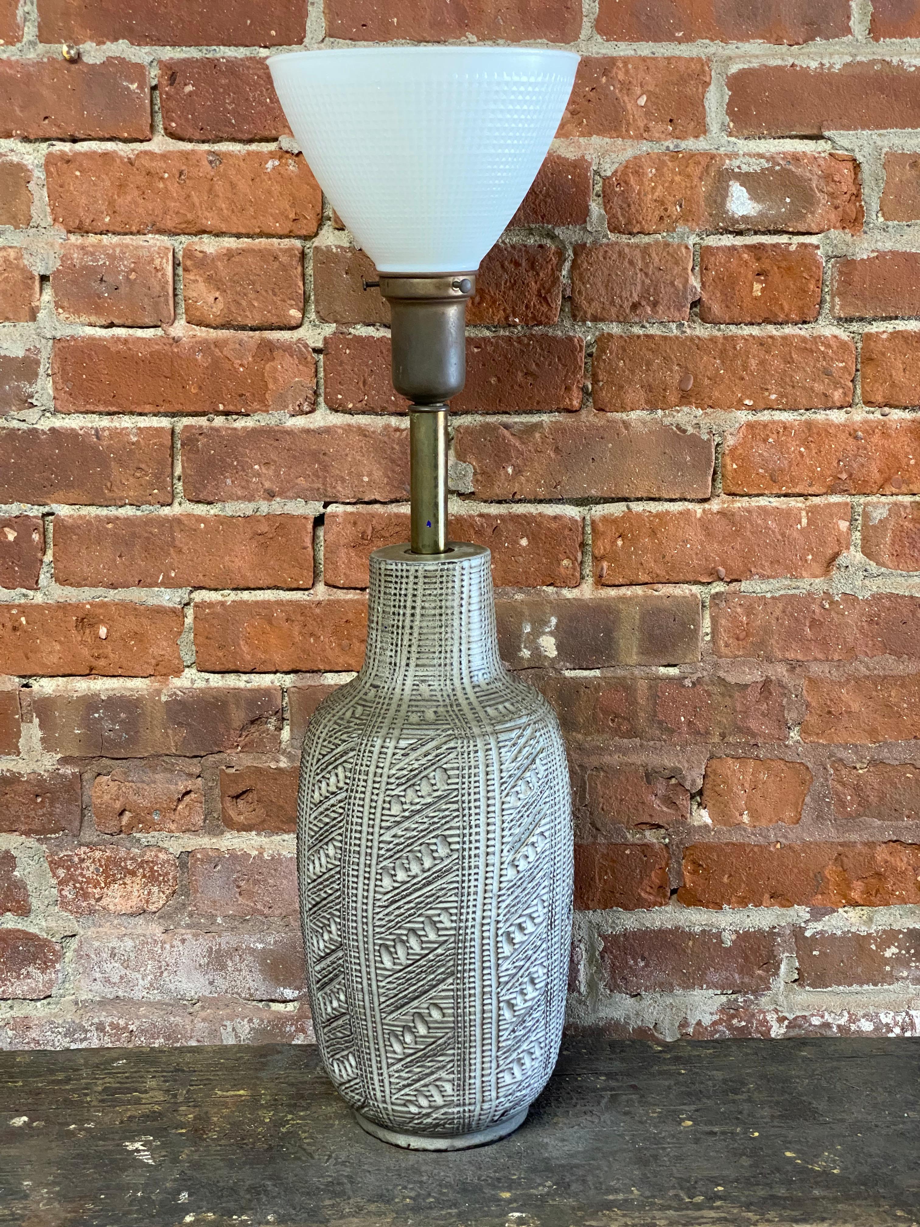 Design Technics art pottery table lamp. Incised decoration. Original working wiring. Milk glass diffuser included. No shade. 

Good overall condition with no visible chips, cracks, crazing, hairlines or restorations.

Approximate measurements