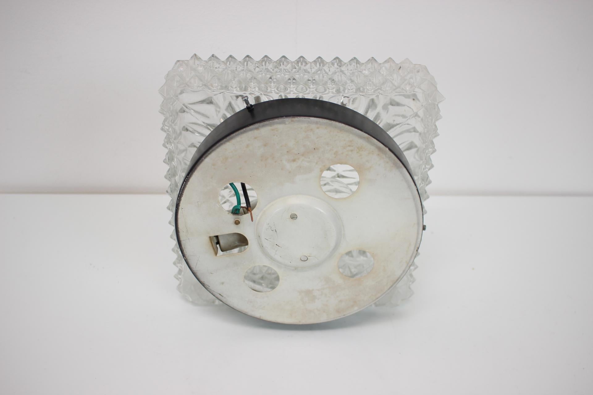 Vintage wall/ceiling lamp, made in the 1970's, in former Czechoslovakia.
Made of metal and glass.
Repolished, cleaned, shows a few minor signs of use, overall in great condition.
Fully functional.