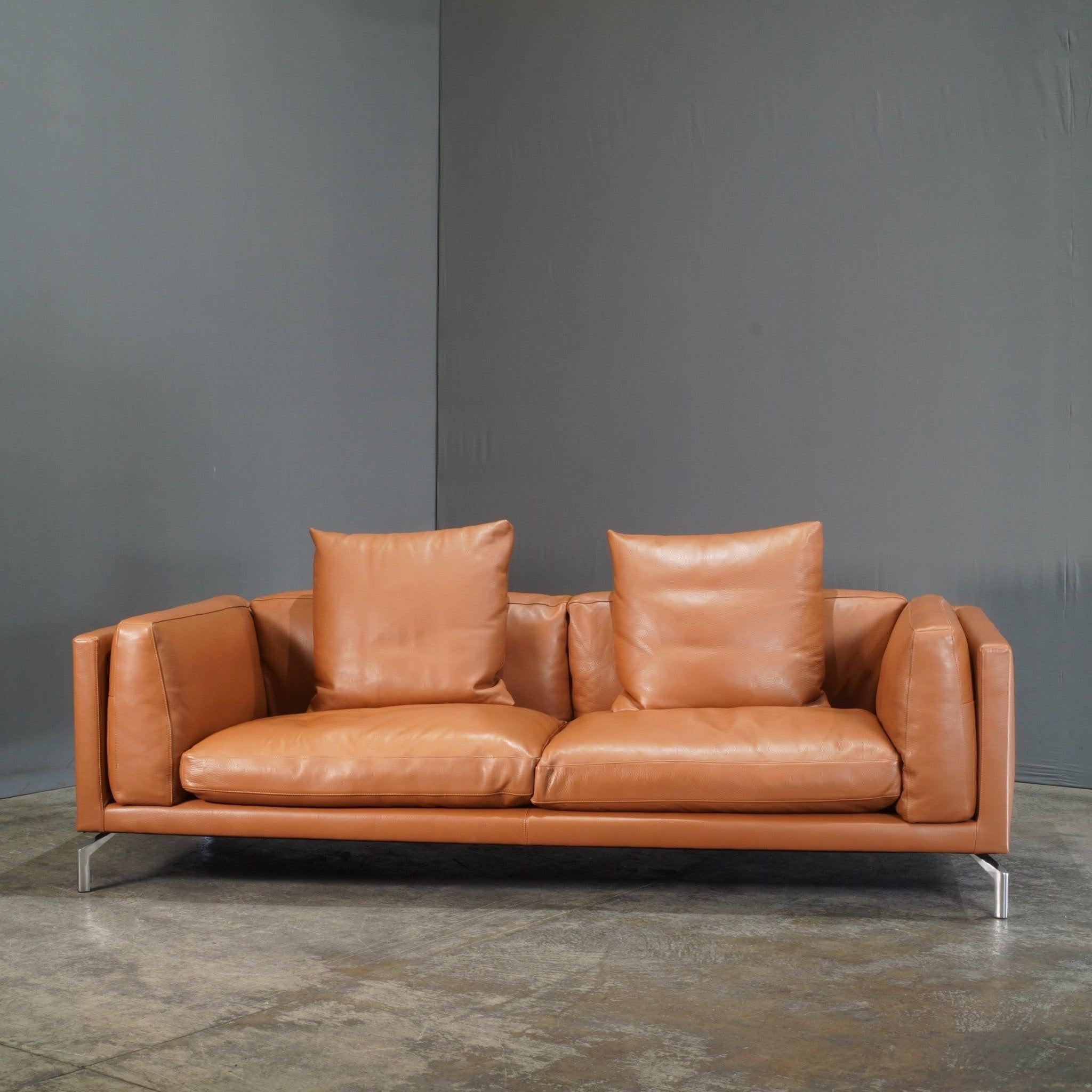 The Design Within Reach Como Leather Sofa by Soressi embodies modern luxury with a minimalist edge. This elegant sofa features sumptuous full-grain leather upholstery, providing a sophisticated and durable seating solution. Designed by the renowned
