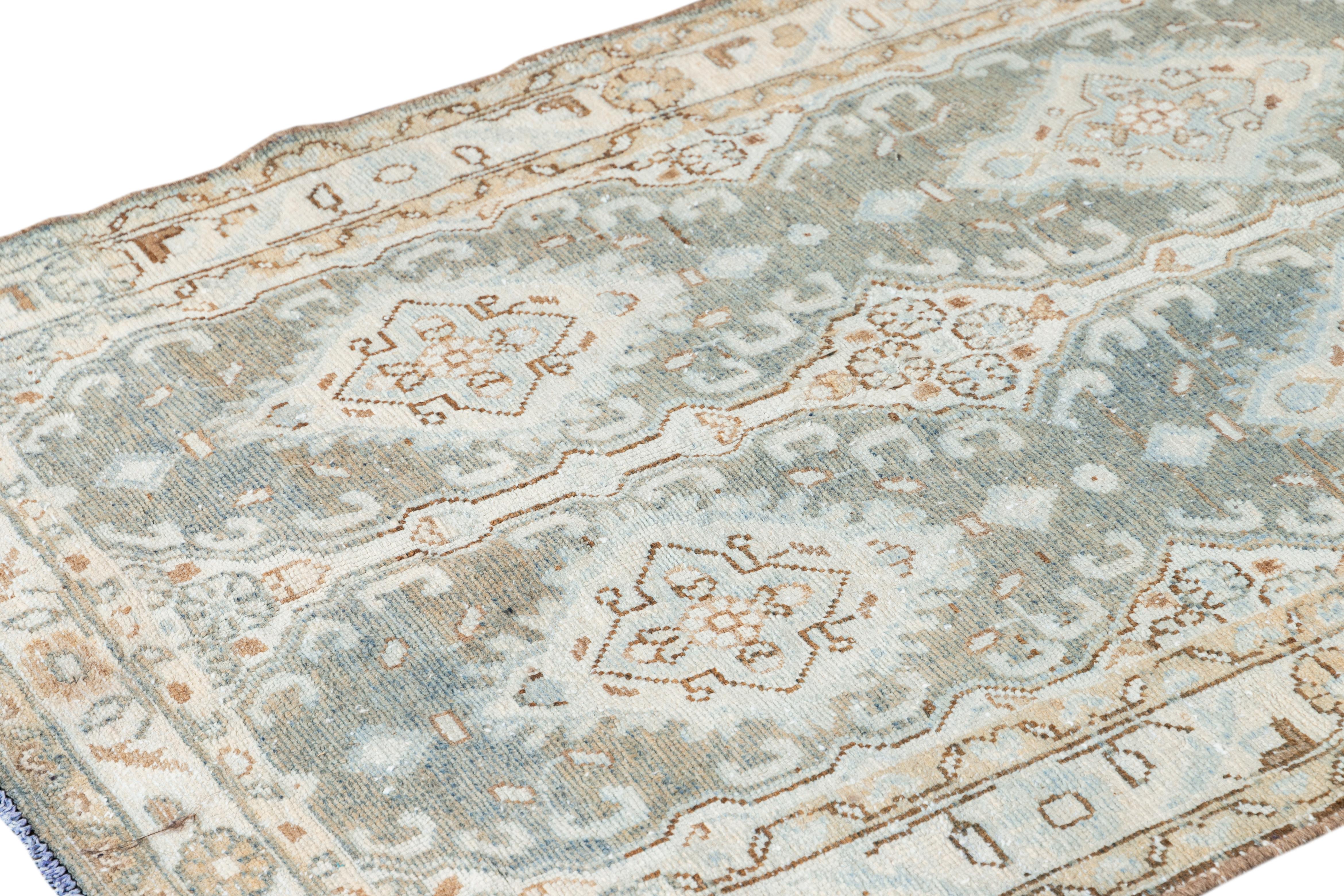 This beautiful, antique Malayer Persian runner rug features a light blue field. The piece showcases brown and beige accents, adorned with an all-over geometric floral design.

This rug measures 3'7