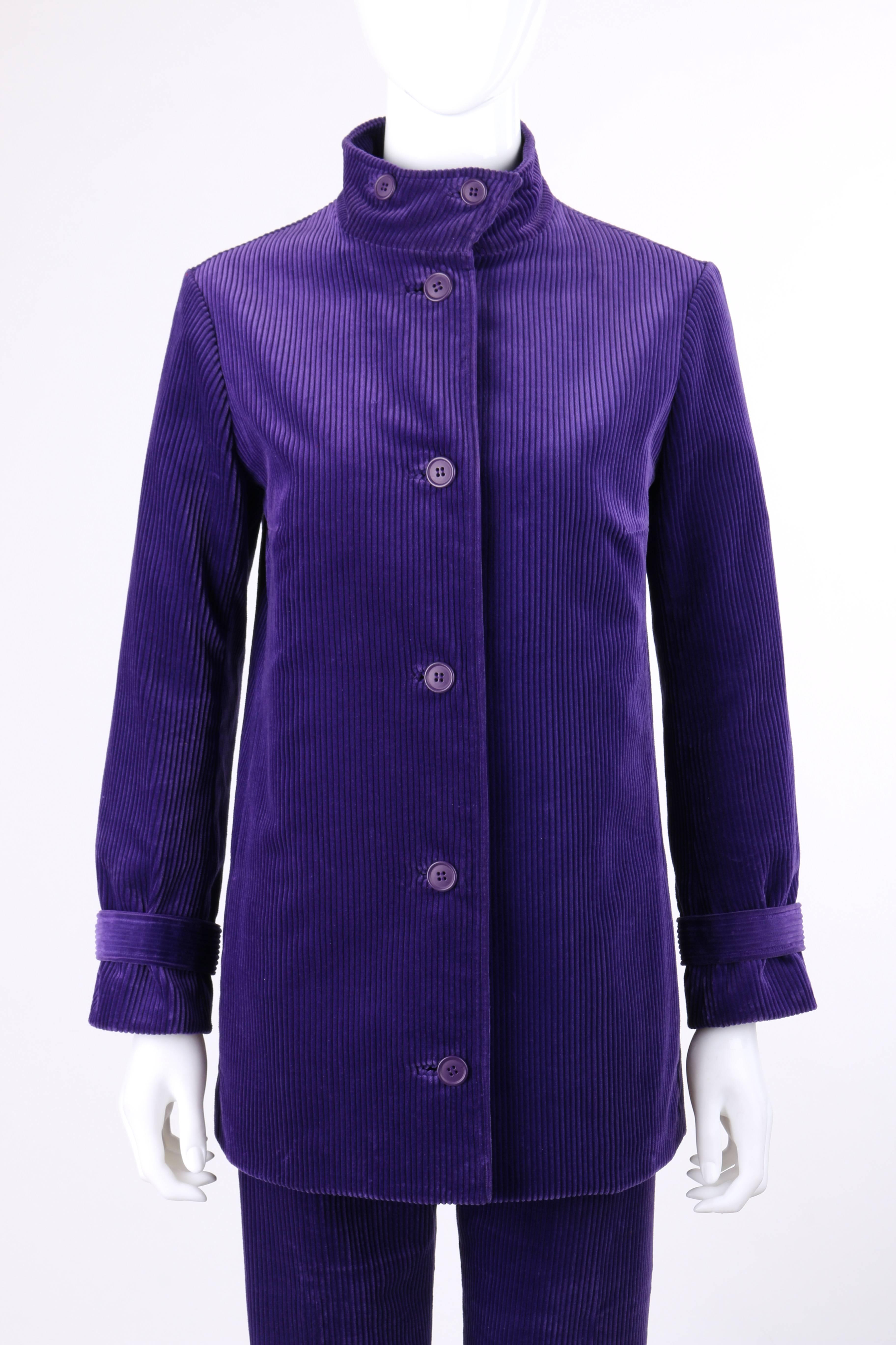 Vintage Designed by Jax c.1960's two piece purple corduroy jacket tapered pants suit set. Mandarin collar jacket with two button closures at front. Five center front button closures. Long sleeves with sleeve strap and single button closure at cuff.
