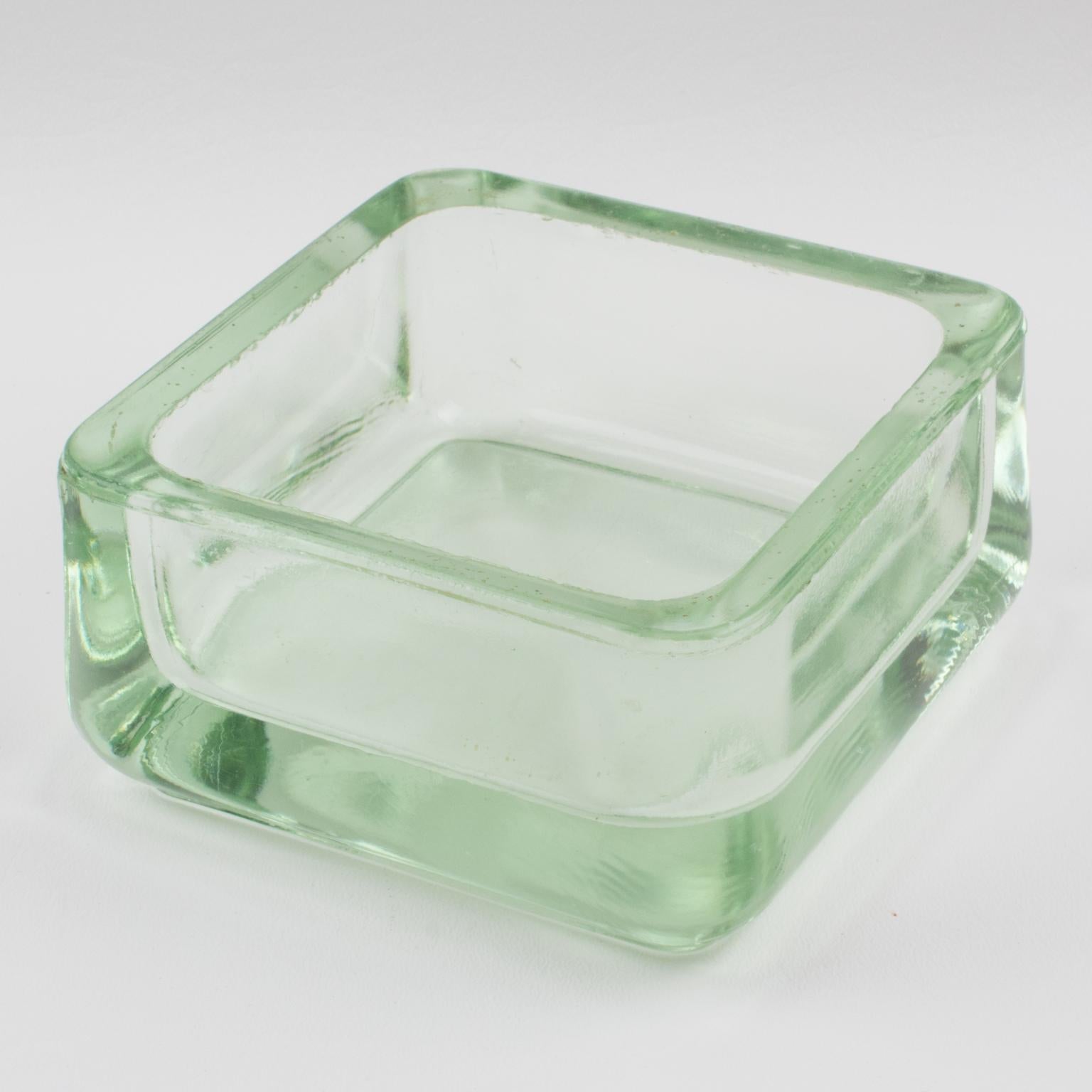 Industrial thick molded glass desktop accessory (desk tidy, ashtray or catchall) manufactured by Lumax, France. Original design by Le Corbusier.
Measurements: 4.75 in. wide (12 cm) x 4.75 in. deep (12 cm) x 2.38 in. high (6 cm).