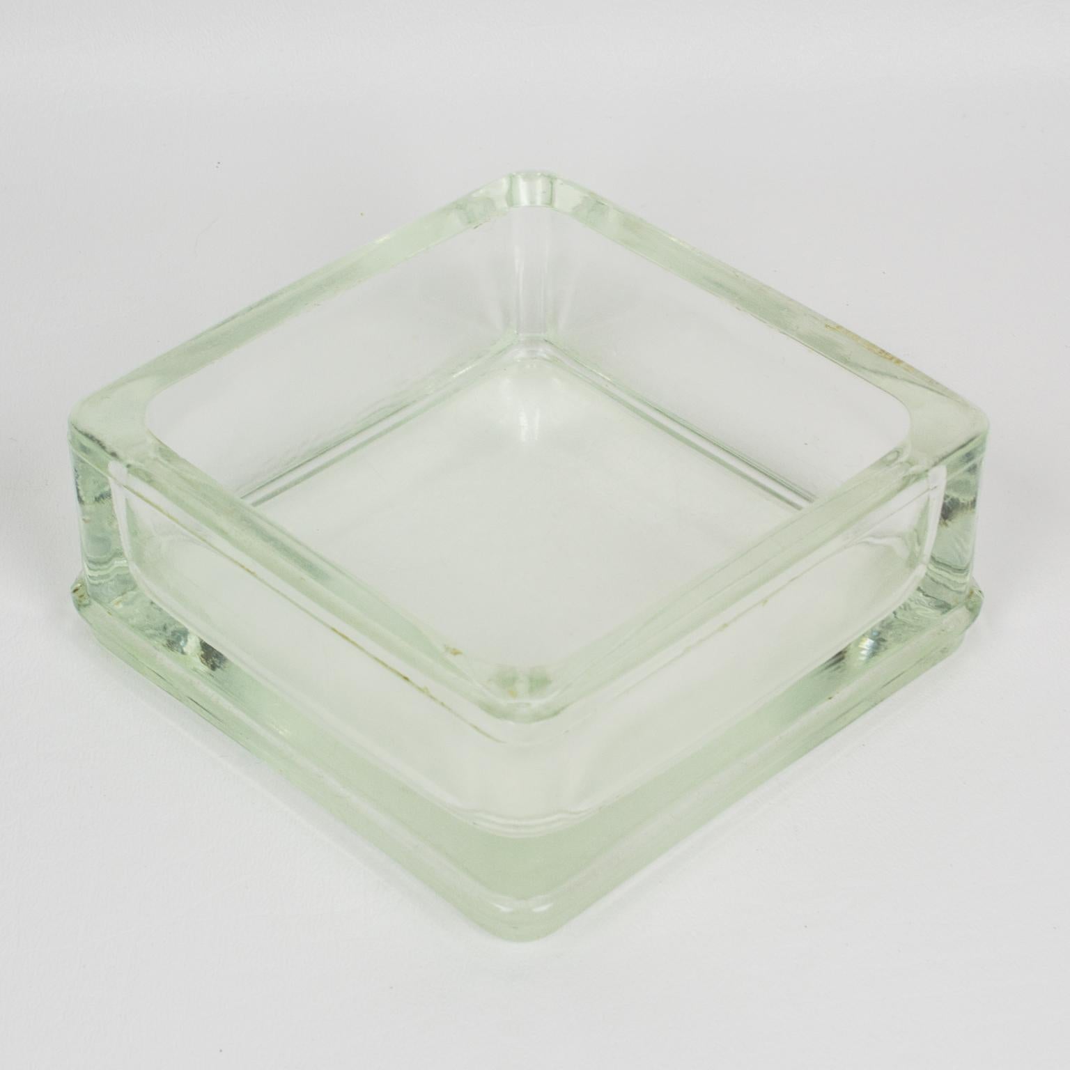 Industrial thick molded glass desktop accessory (desk tidy, ashtray or catchall) manufactured by Lumax, France. Original design by Le Corbusier.
Measurements: 4.50 in. wide (11.5 cm) x 4.50 in. deep (11.5 cm) x 2 in. high (5 cm).