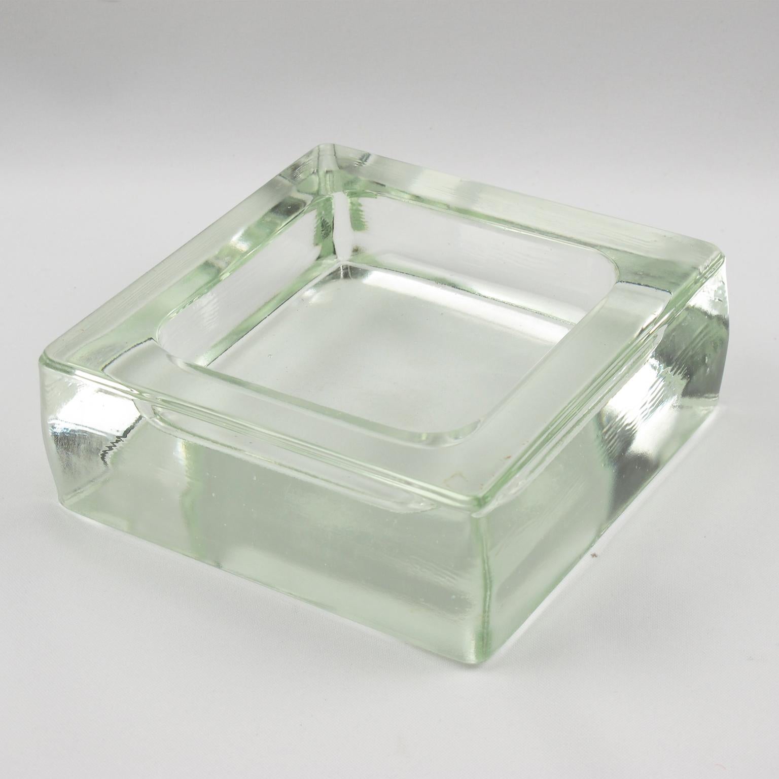 Industrial thick molded glass desktop accessory, desk tidy, cigar ashtray or catchall, manufactured by Lumax, France. Original design by Le Corbusier. No visible marking.
Measurements: 5.50 in. wide (14 cm) x 5.50 in. deep (14 cm) x 2 in. high (5