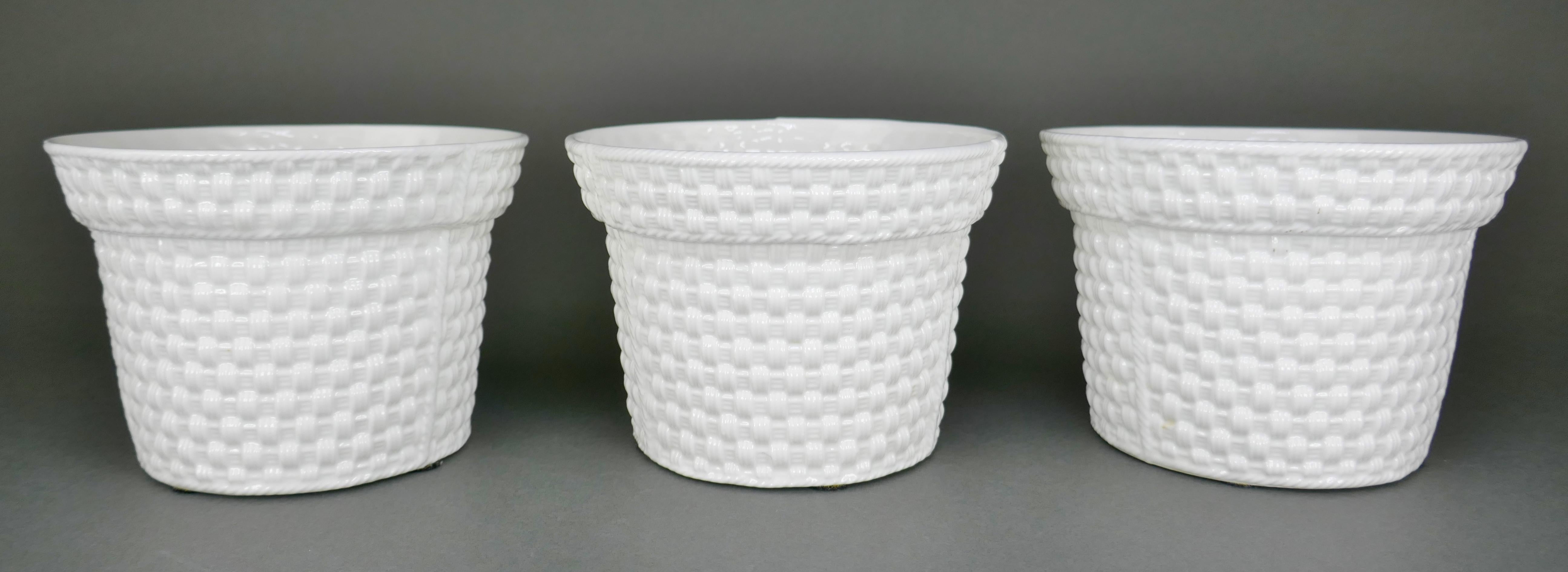 Set of three small basketweave porcelain flower pots designed by Irish fashion designer Sybil Connolly for Tiffany & Co. They are in perfect condition. 