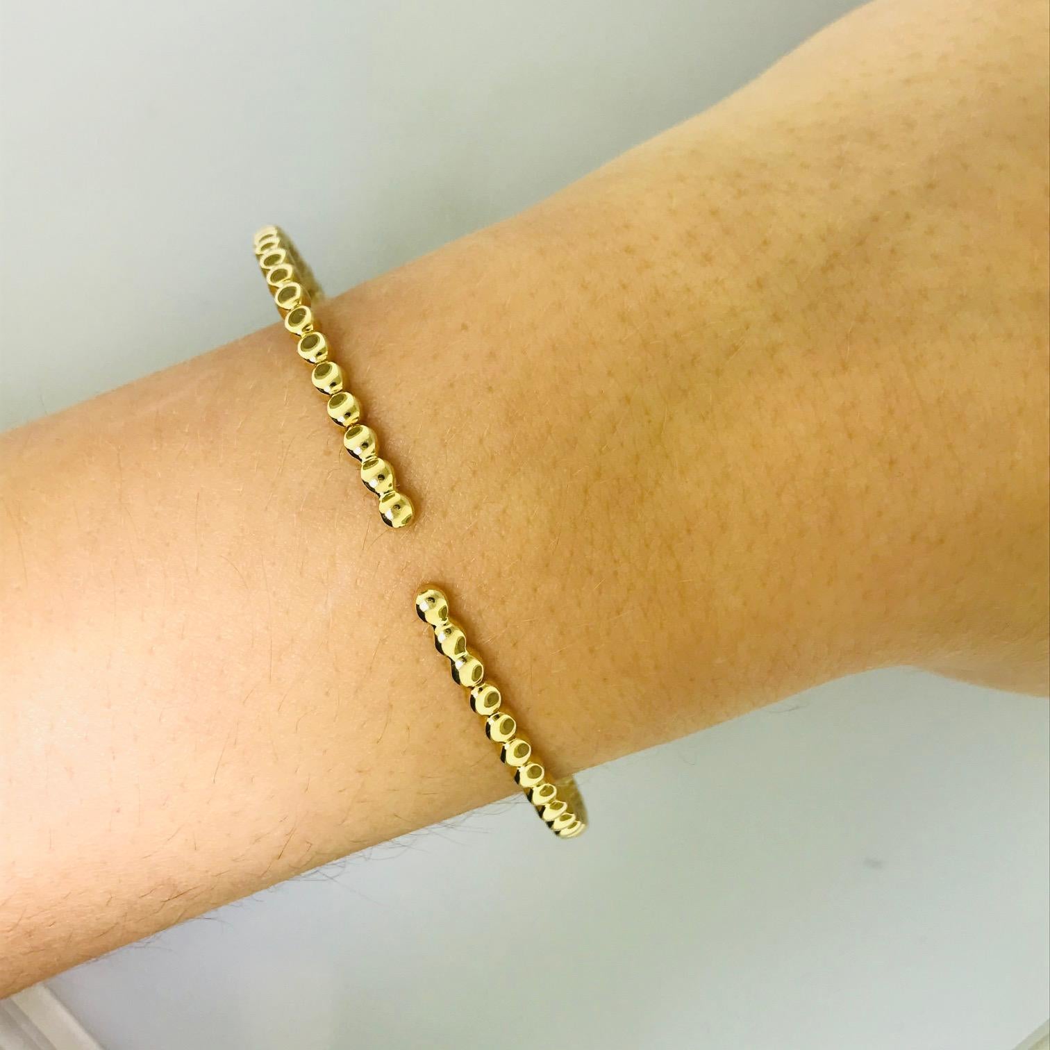 FUN! COLLECTIBLE! DESIGNER! FASHION BANGLE BRACELET! 

This fun designer bangle bracelet is so adorable and looks great on everyone! The bracelet is 14 karat yellow gold and flexible, meant to fit any wrist! With a unique bead-like design this