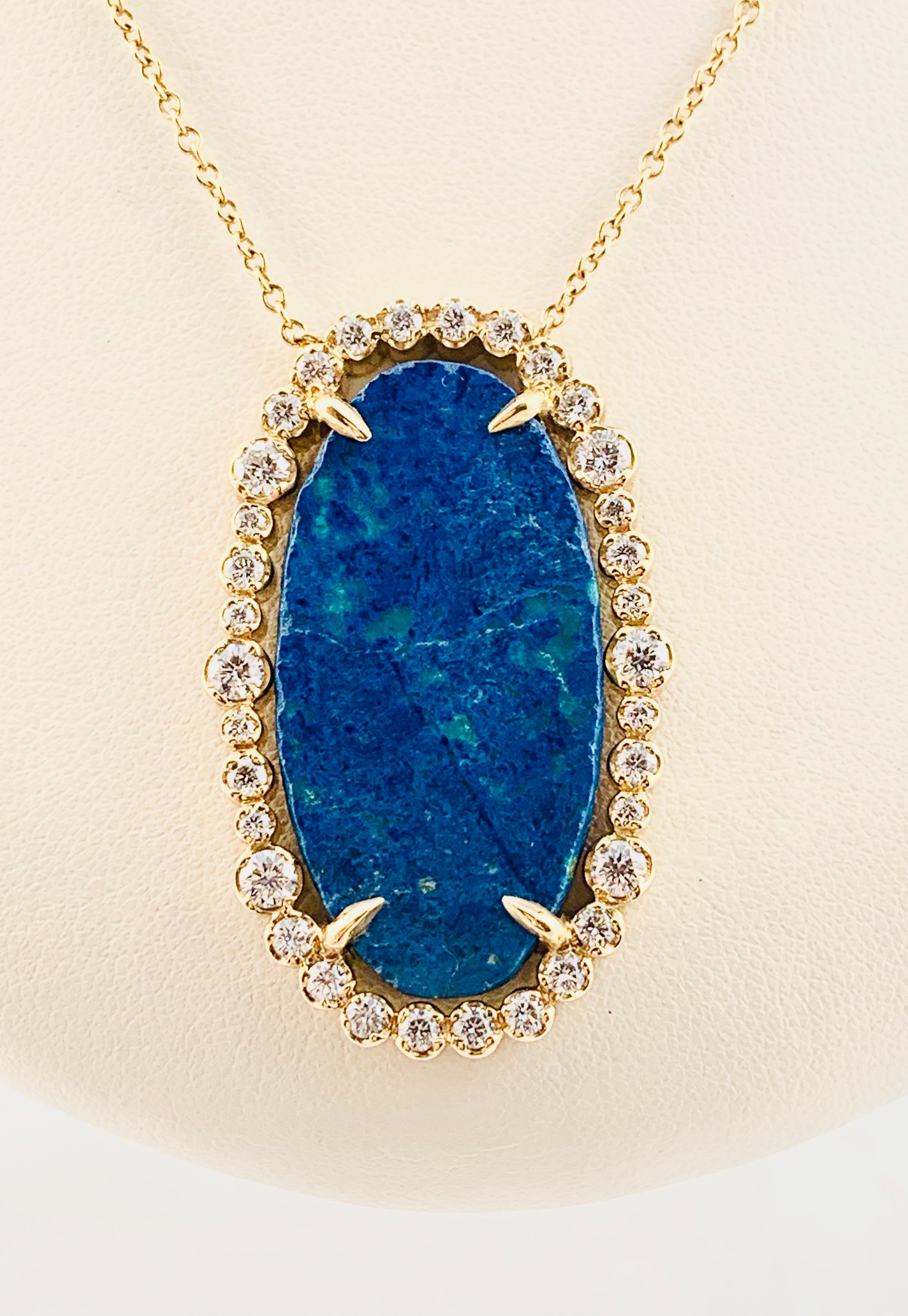 Absolutely Stunning designer necklace! This piece is made in 18k yellow Gold and Features a single, oval, 12 carat center Azurite Stone that is surrounded by 34 Brilliant diamonds. The diamonds are H-I in color and Vs2 in clarity. The diamonds have