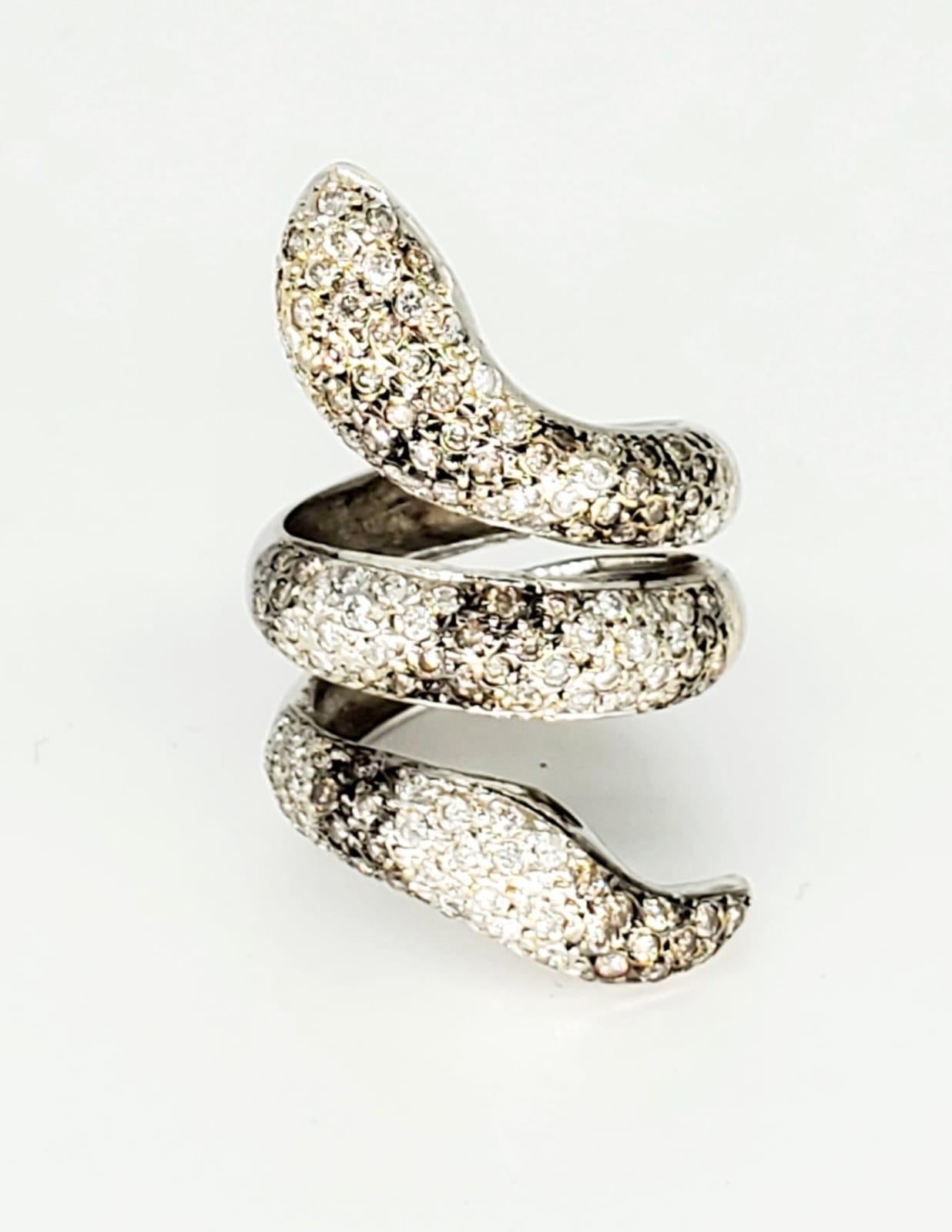 Designer ring from Brazil featuring at outstanding work of craftsmanship of a Rattle Snake. There is a total of 3 carats SI Clarity diamonds. The ring is a size 6.5 and weights 12 grams solid 18 gold.