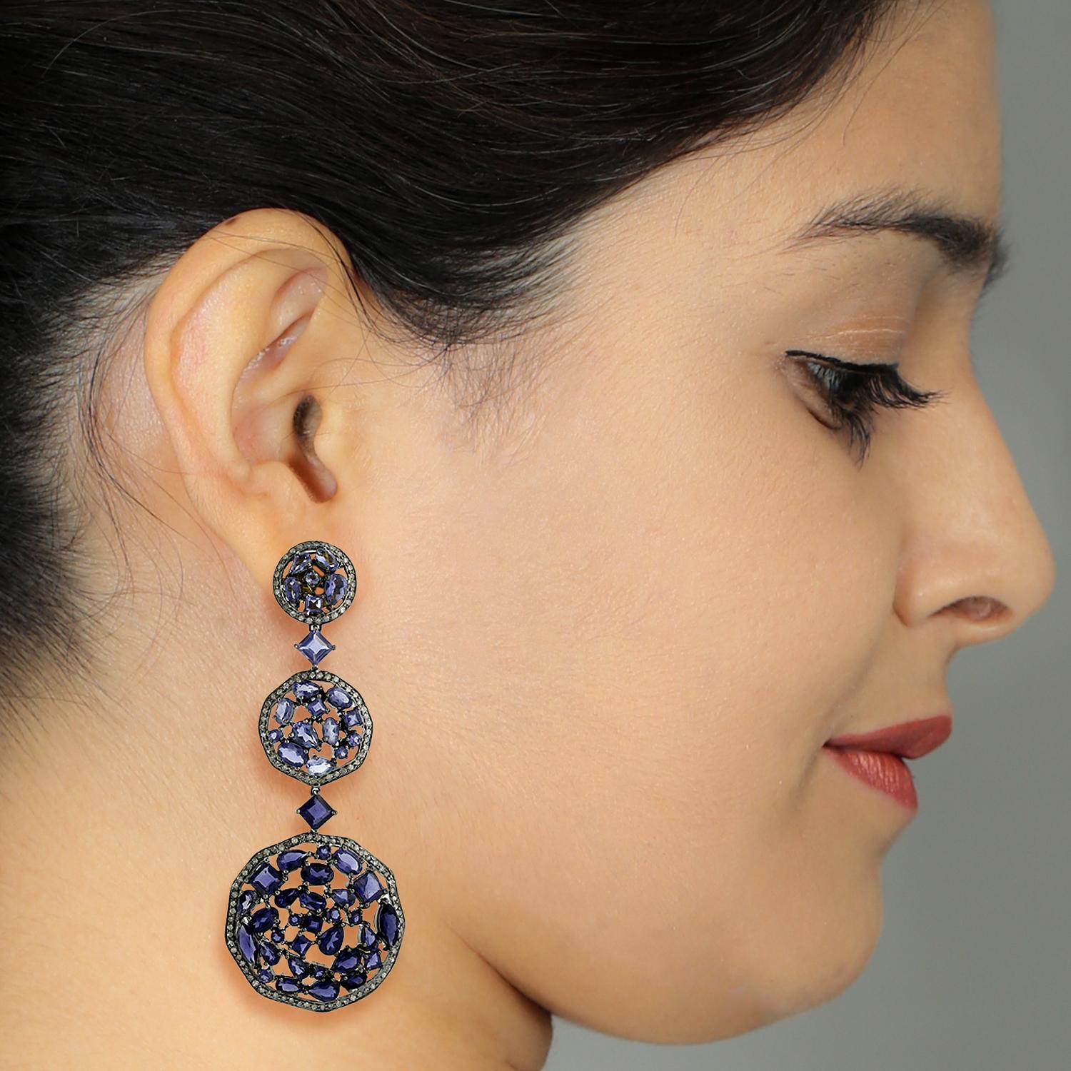 This designer 3 Tier Mosaic Iolite and Diamond Dangle Earring in Silver and Gold is dressy, fun and unique.

18kt gold:2.97gms
Diamond:3.26cts
Silver:26.4gms
Iolite:26.86cts
