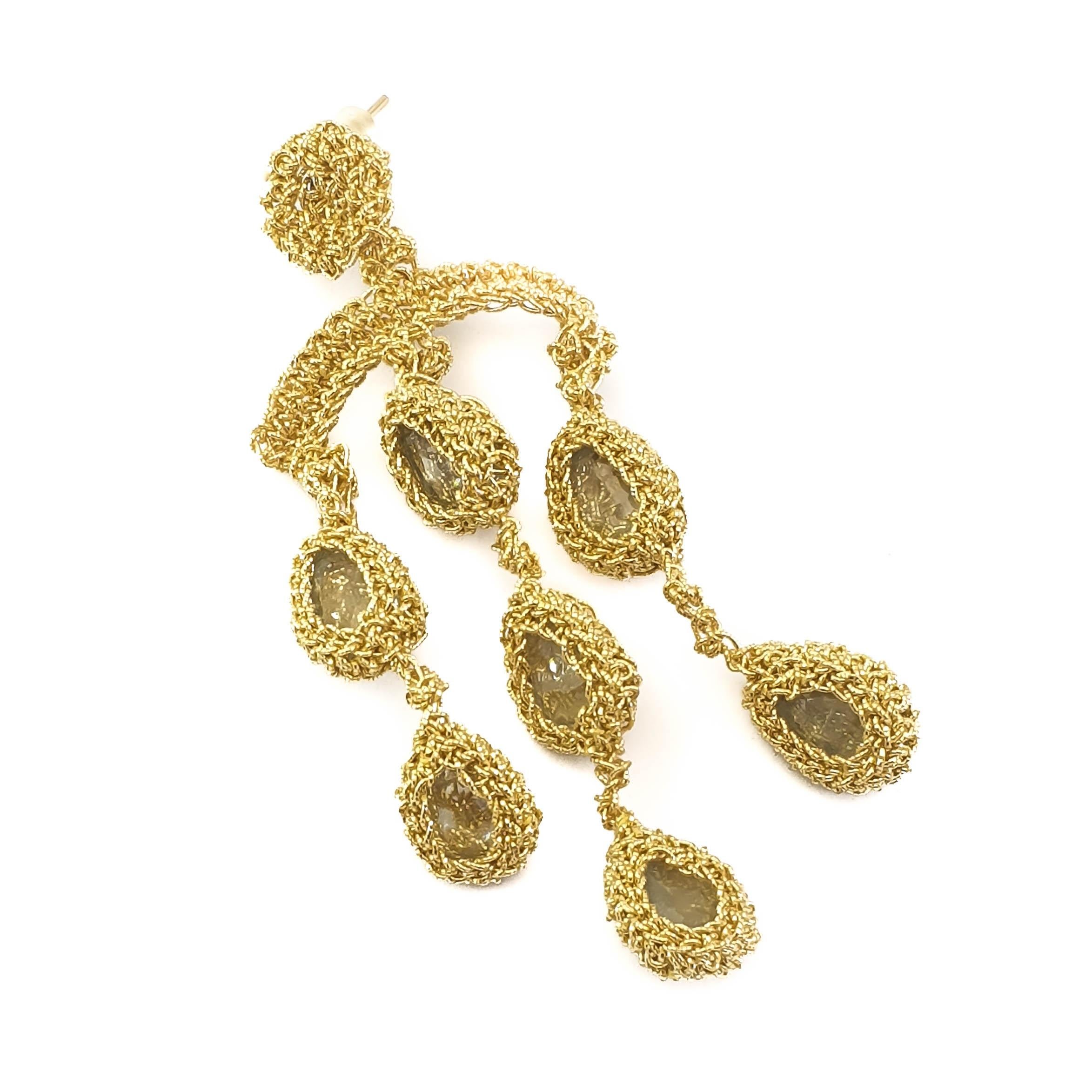 One of a Kind 18 karat gold crochet thread with 7 pear shape Aquamarines Chandelier 
earrings. Earrings are hand crochet by the artist. The gold thread is tightly crochet around the Aquamarines. The earring post is crochet with the gold thread.