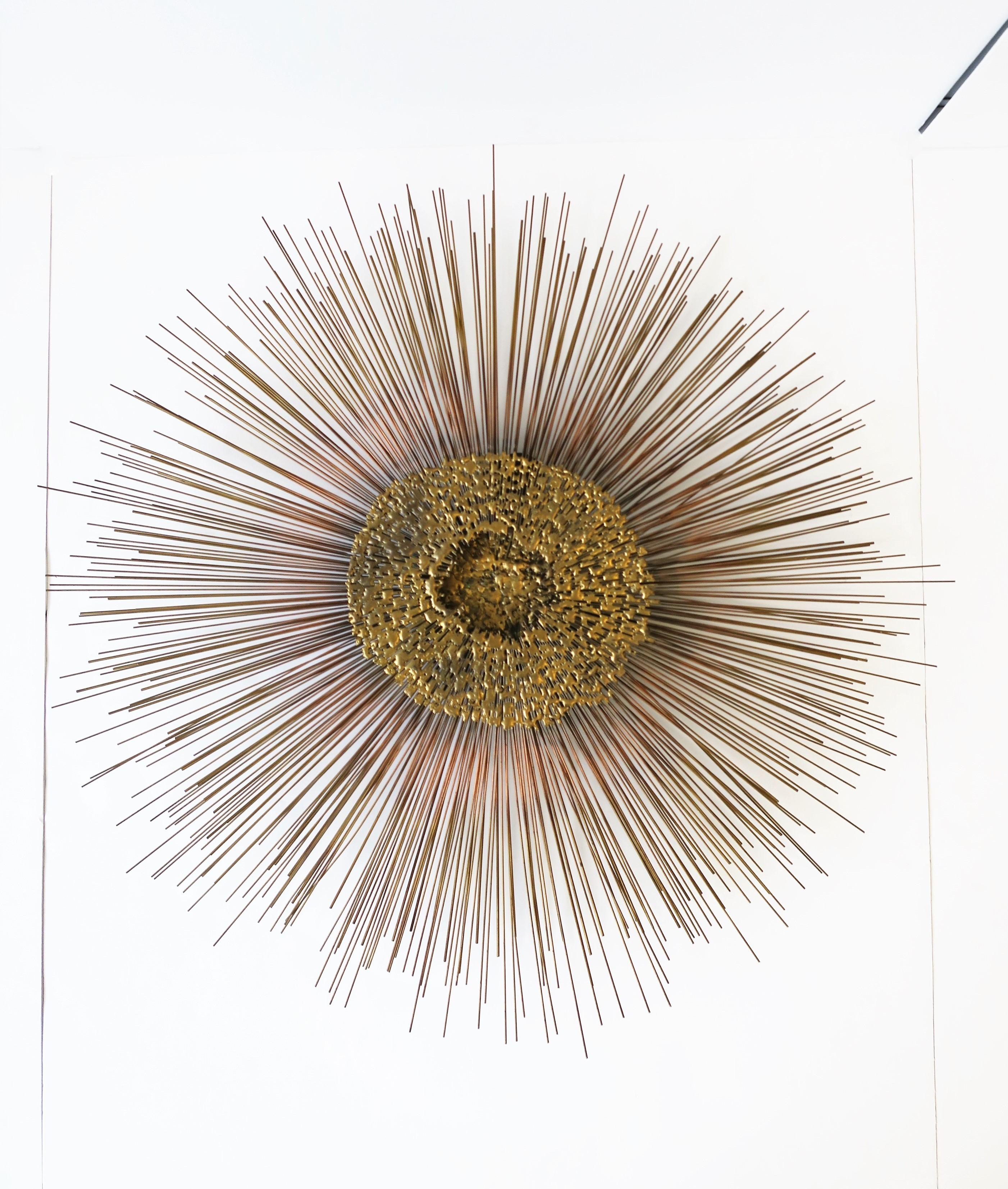 A substantial and well made modern late 1970s brass and bronze metal wall art sculpture piece made by designer Friedle, late 20th century, circa late 1970s, USA. This modern metal starburst sculpture, by Bruce and William Friedle, brothers and