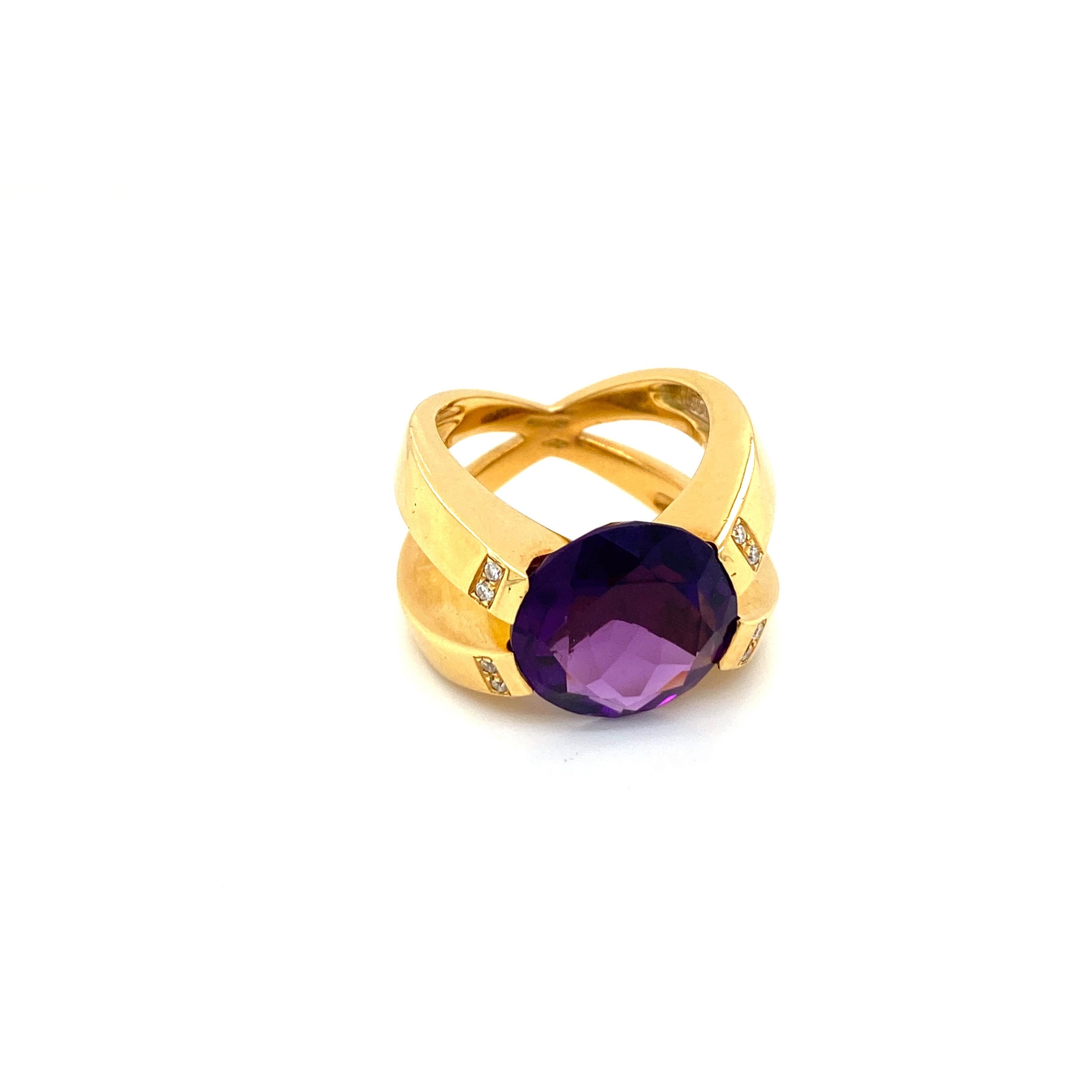 Unusual 18k yellow Gold, Amethyst and Diamond Design Ring, set in the center with a Round brilliant-cut Vivid Natural Amethyst, weighing approximately 10 carats, flanked by 8 Round Brilliant cut diamonds graded Color G. clarity VvS.

Handmade in